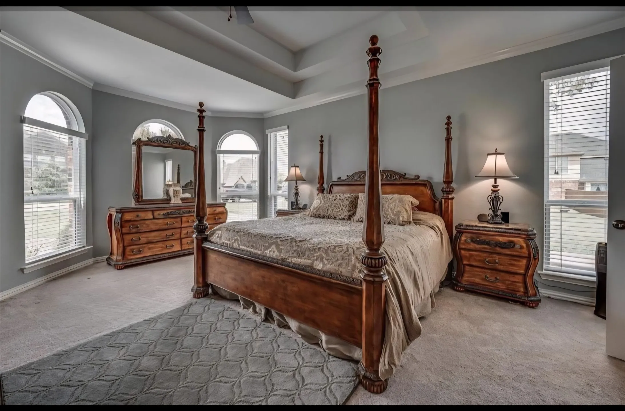 PRIMARY BEDROOM SUITE IS OVERSIZED AND FEATURES TRAY CEILING DETAIL