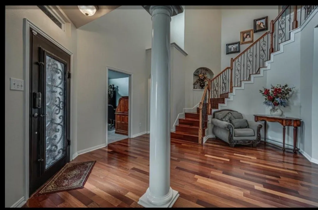 GRAND FOYER ENTRYWAY WITH CUSTOM IRON DOOR AND STUNNING IRON RAILING WORK