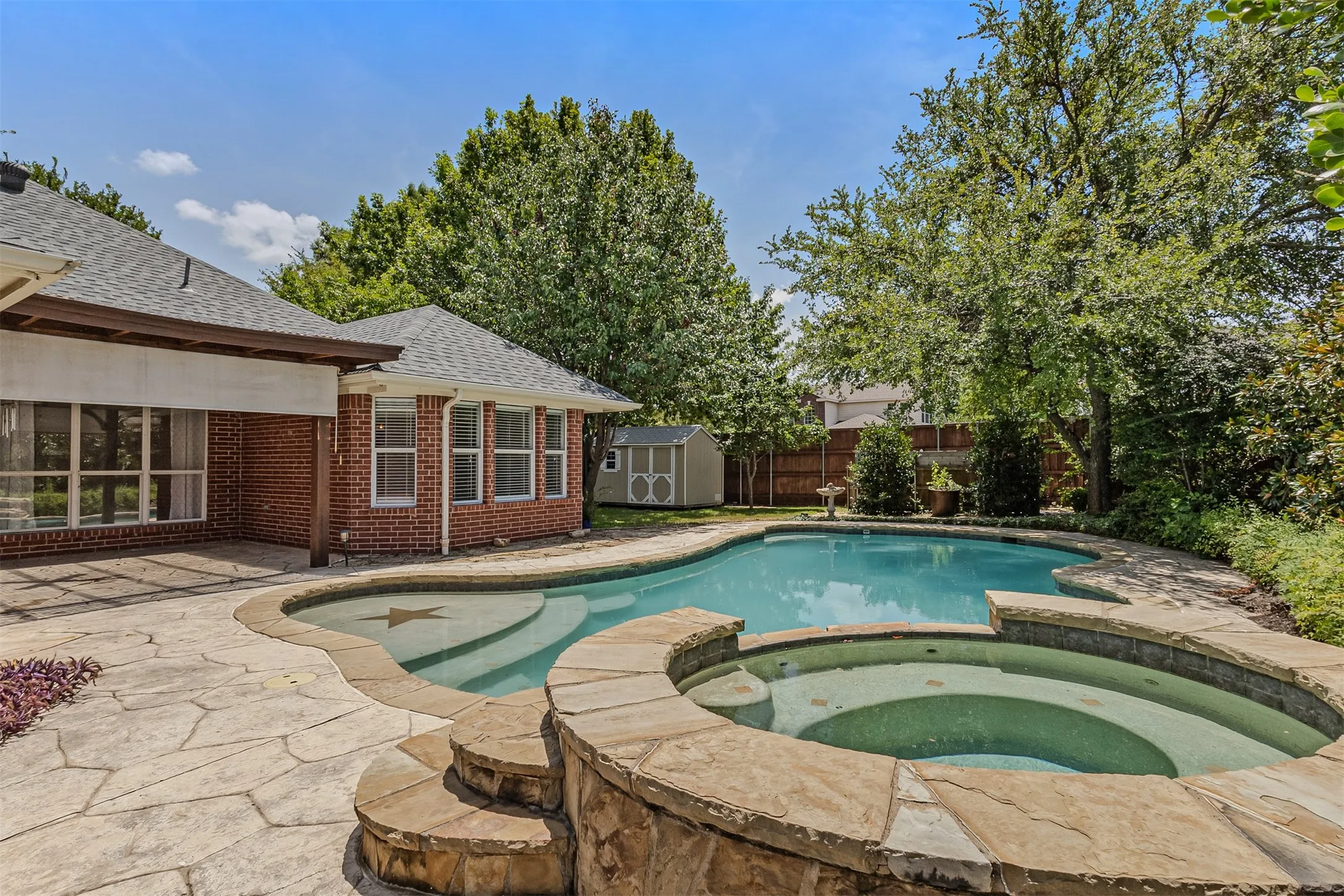 Gorgeous backyard with pool and heated spa with plenty of grass for pets and a 10 x 12 shed