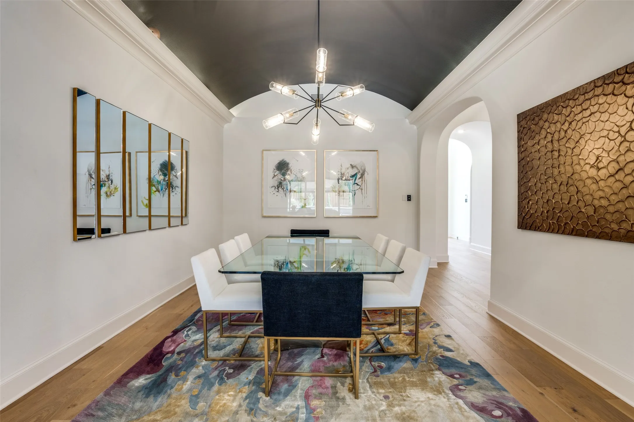 Vaulted ceiling with dark accent paint and crown molding