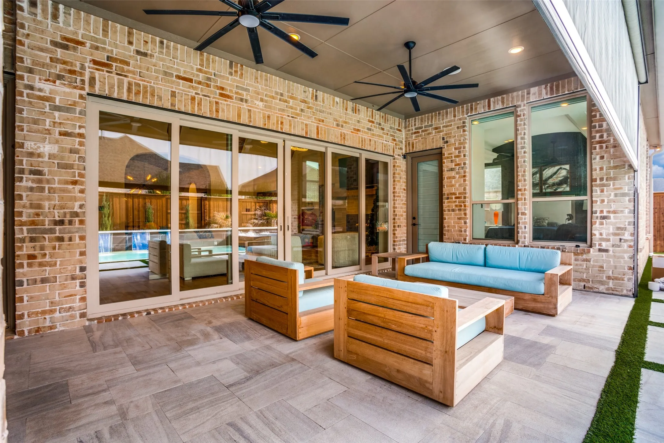 Covered patio featuring a brick exterior and a tiled floor