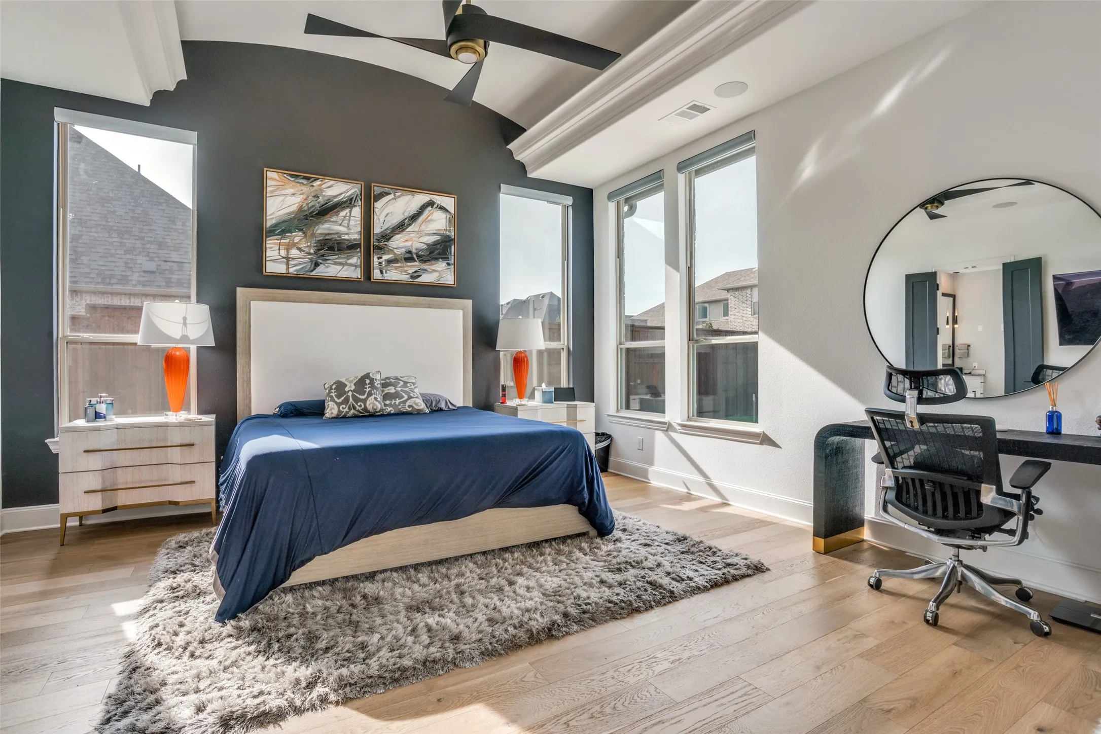 Bedroom with wood-finish flooring, a vaulted ceiling, and a ceiling fan