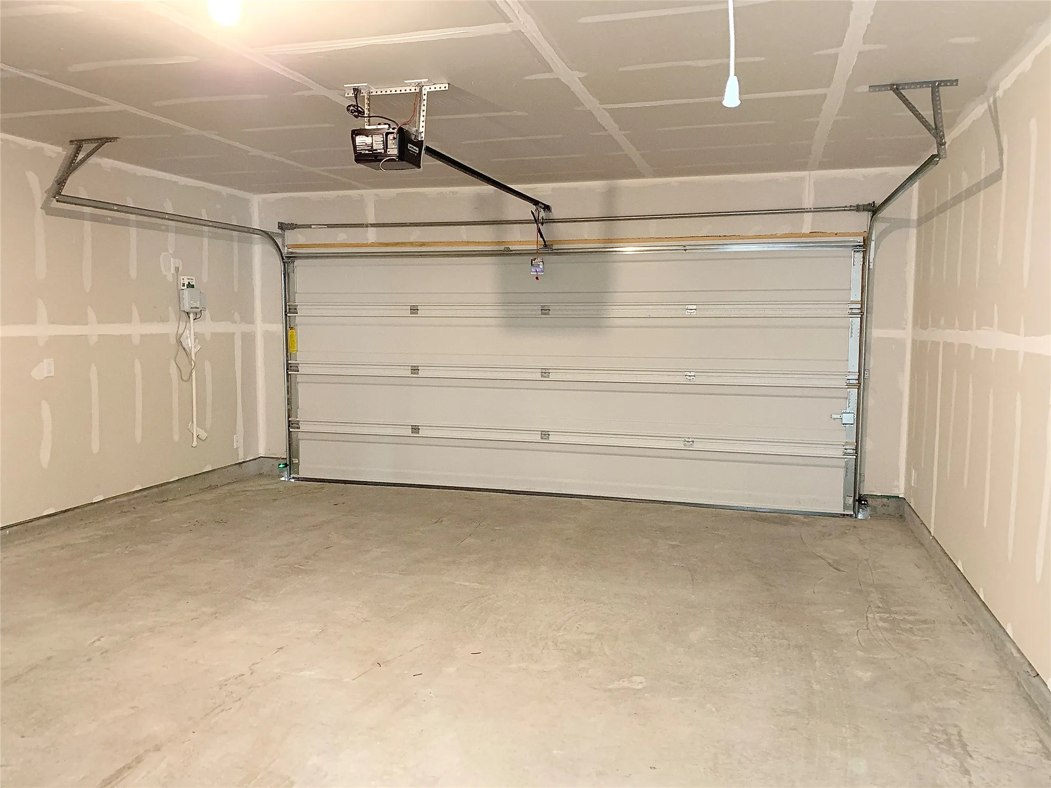 Garage featuring a garage door opener