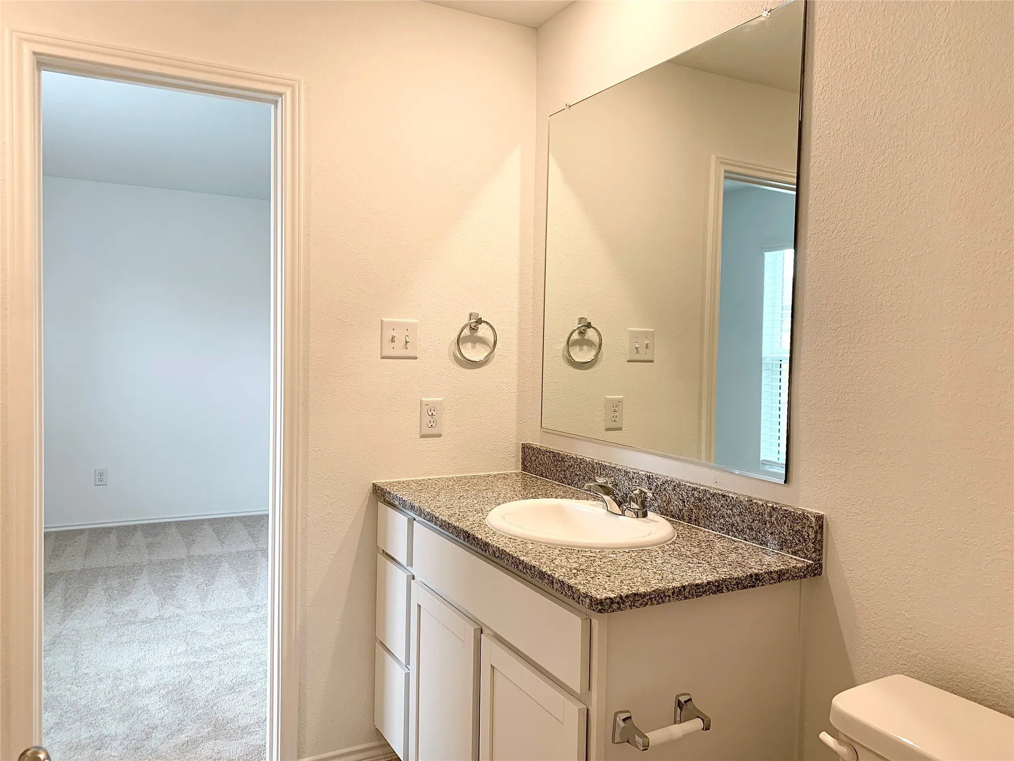 Bathroom featuring toilet and large vanity