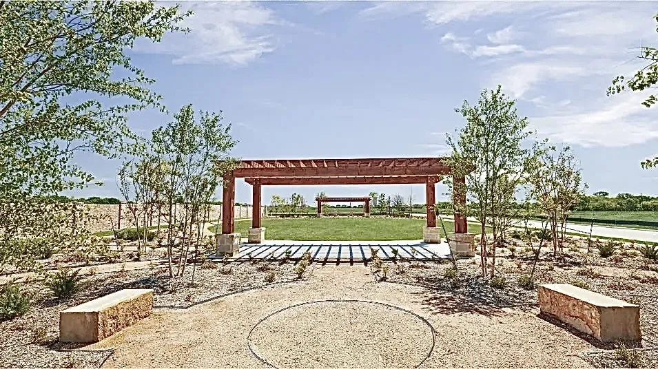 View of property's community featuring a pergola and a yard