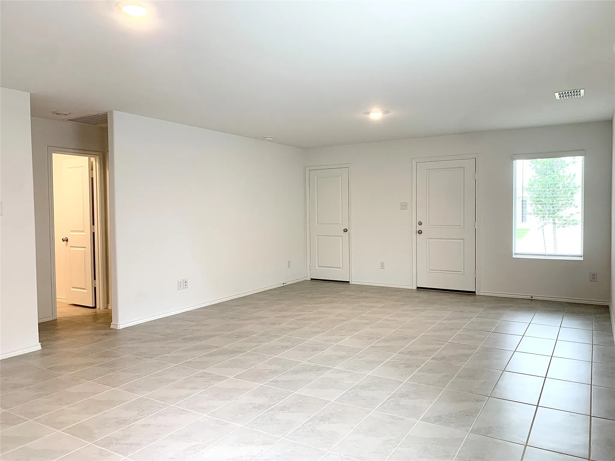 Huge living area with light tile floors