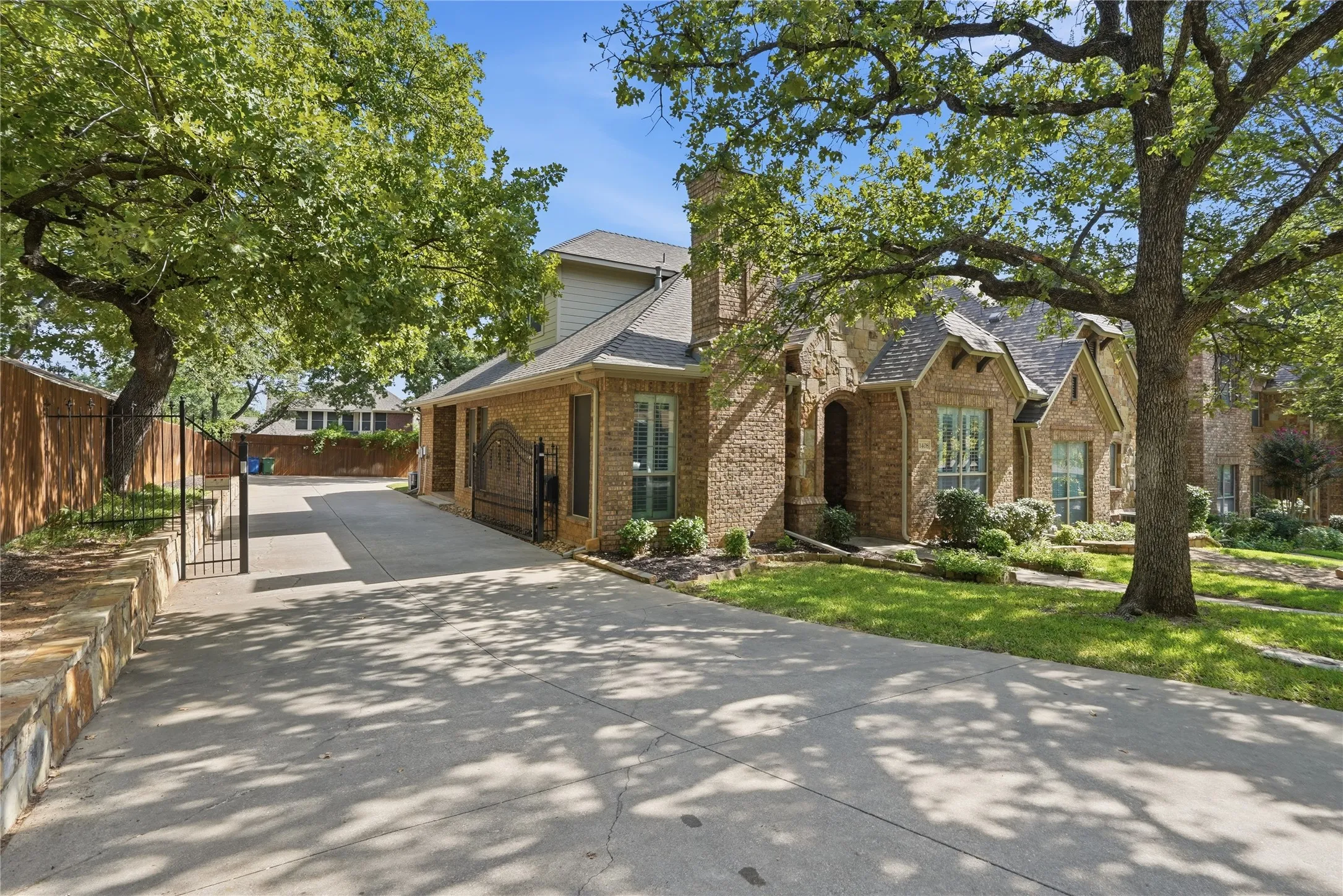 Brick and stone exterior featuring a steeply pitched roofline and decorative gables