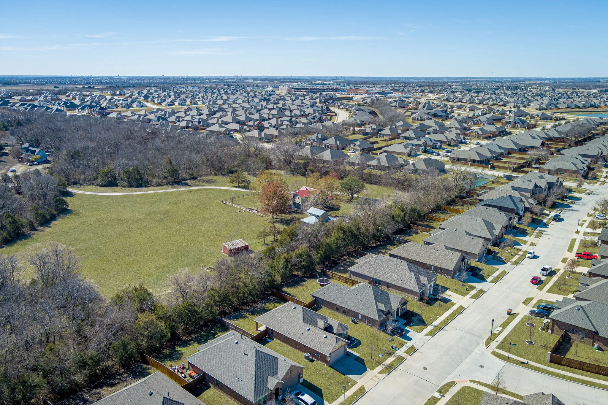 Aerial view of property's location with nearby suburban area
