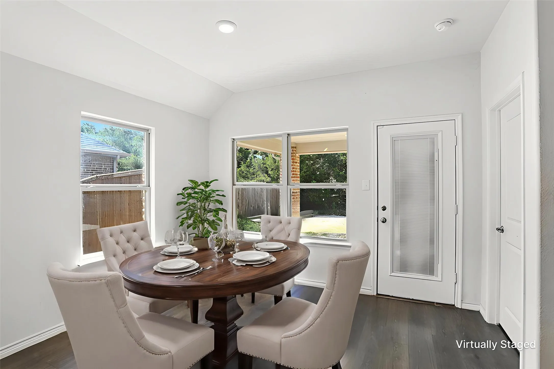 Dining room featuring lofted ceiling and dark wood finished floors
