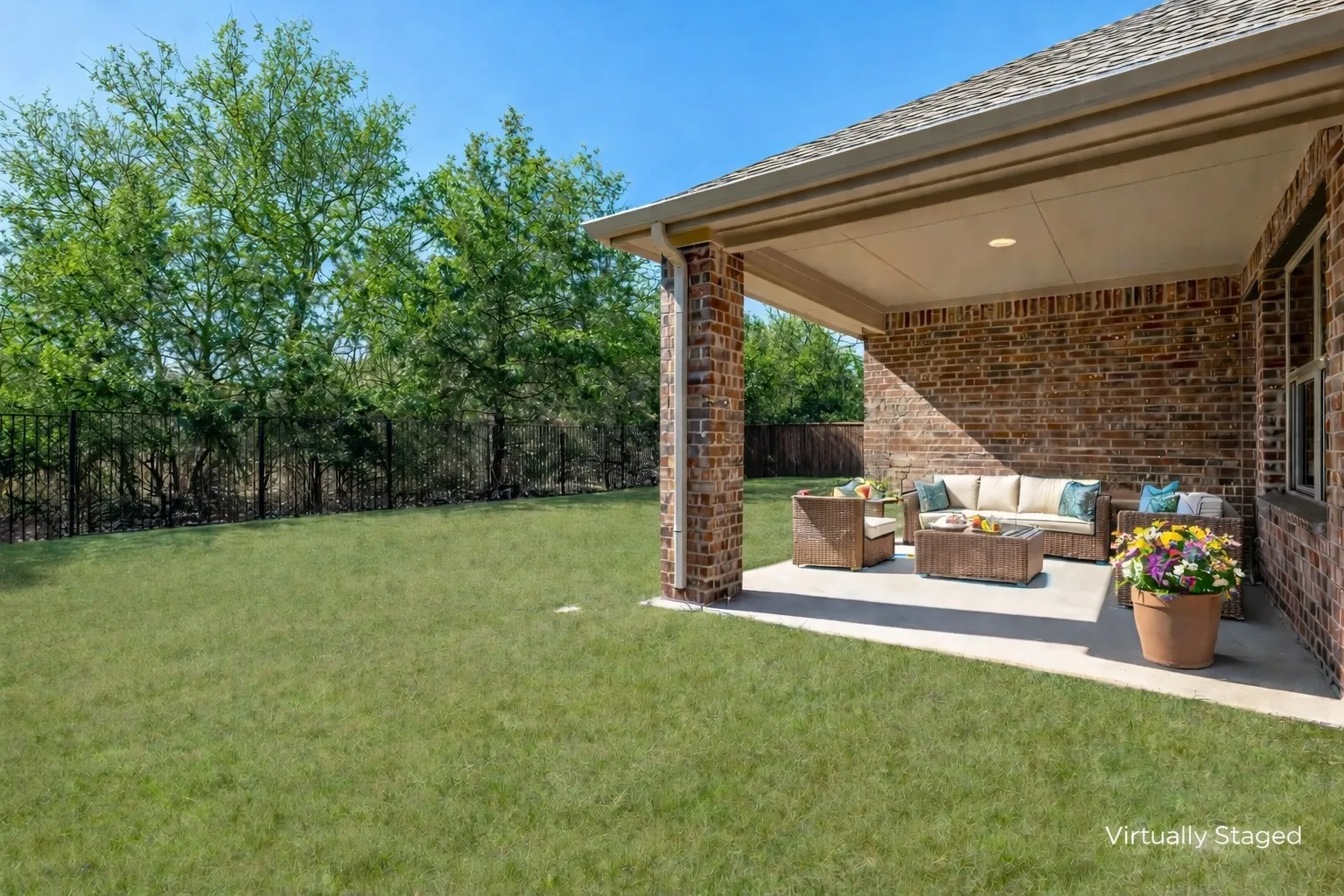 Fenced backyard with an outdoor lounge area and a patio area