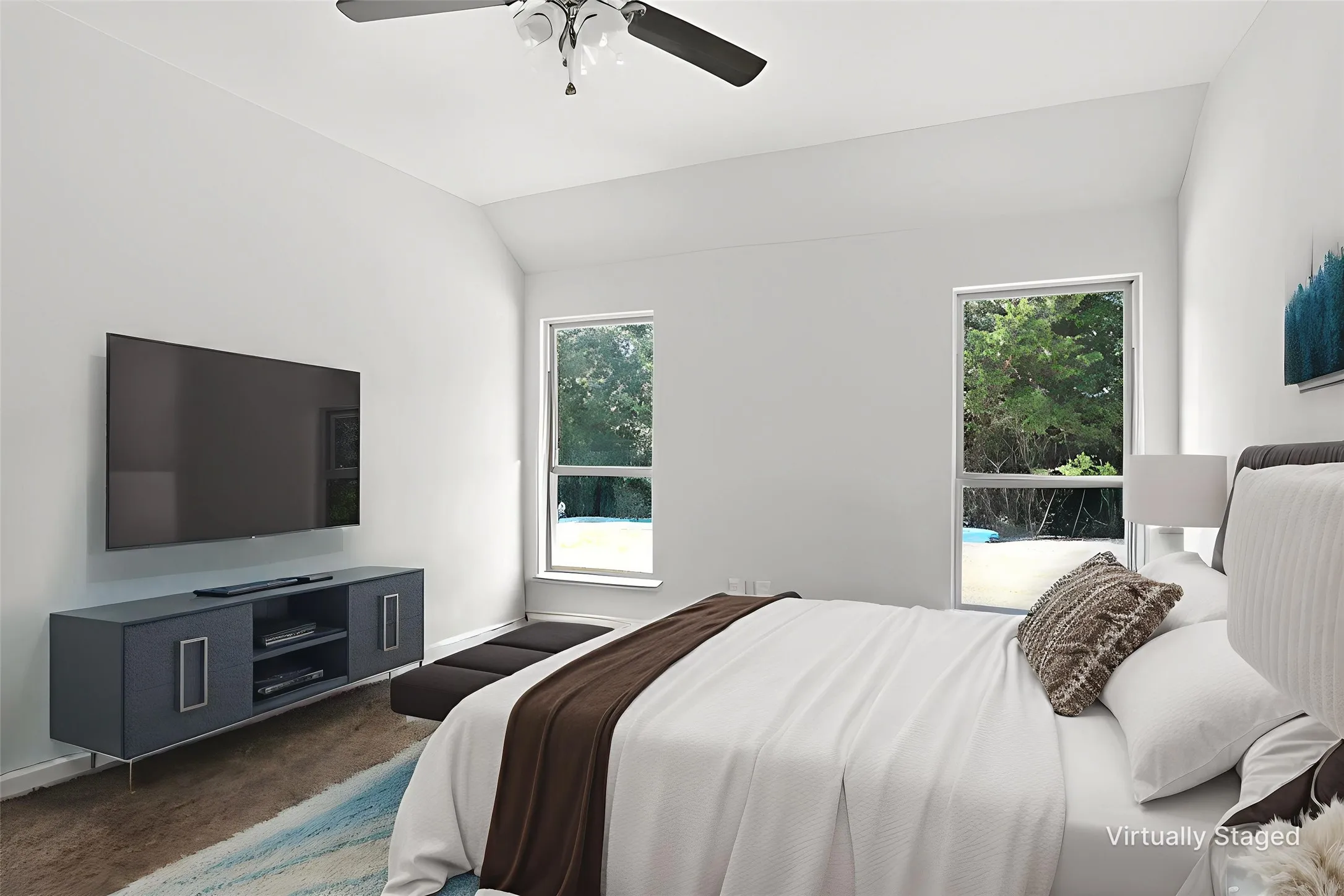 Bedroom with vaulted ceiling, carpet floors, and ceiling fan