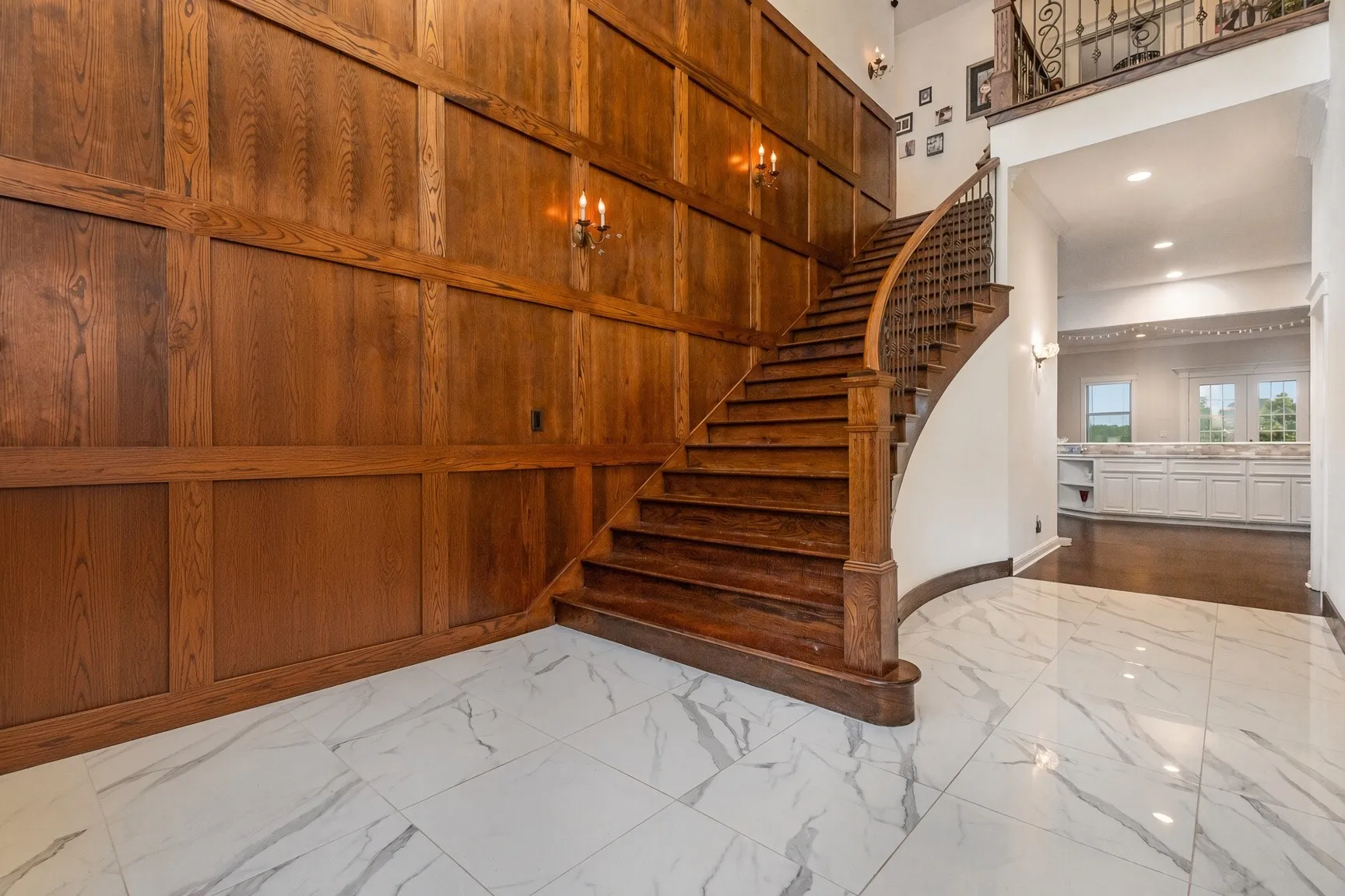 Wood-paneled wall with sconce lighting
