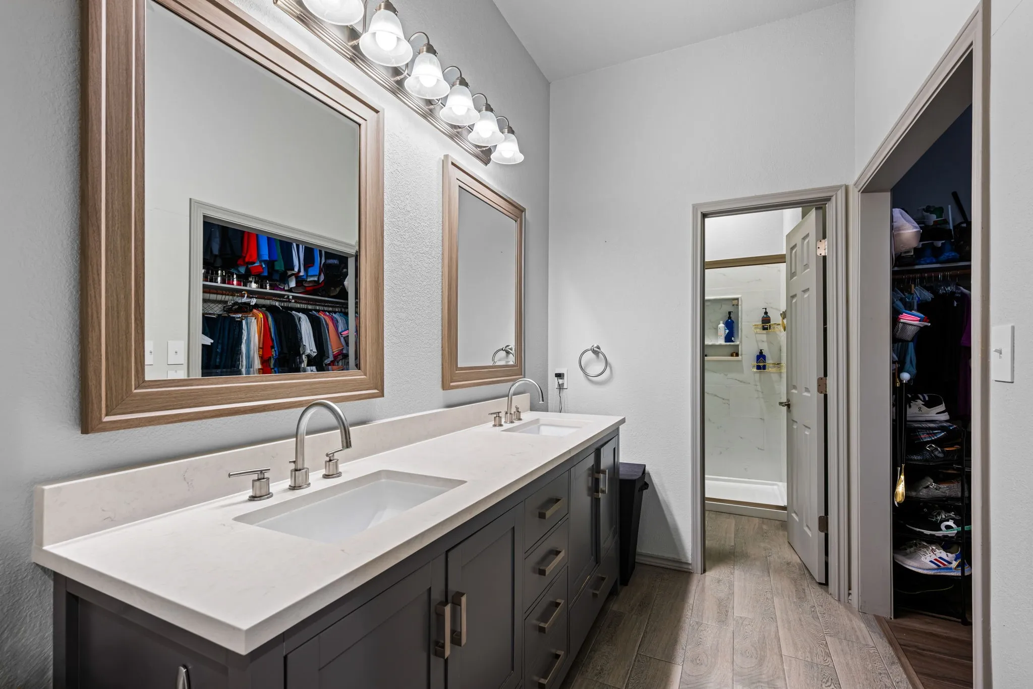The primary bathroom features a large vanity with 2 sinks as well as a walk in closet
