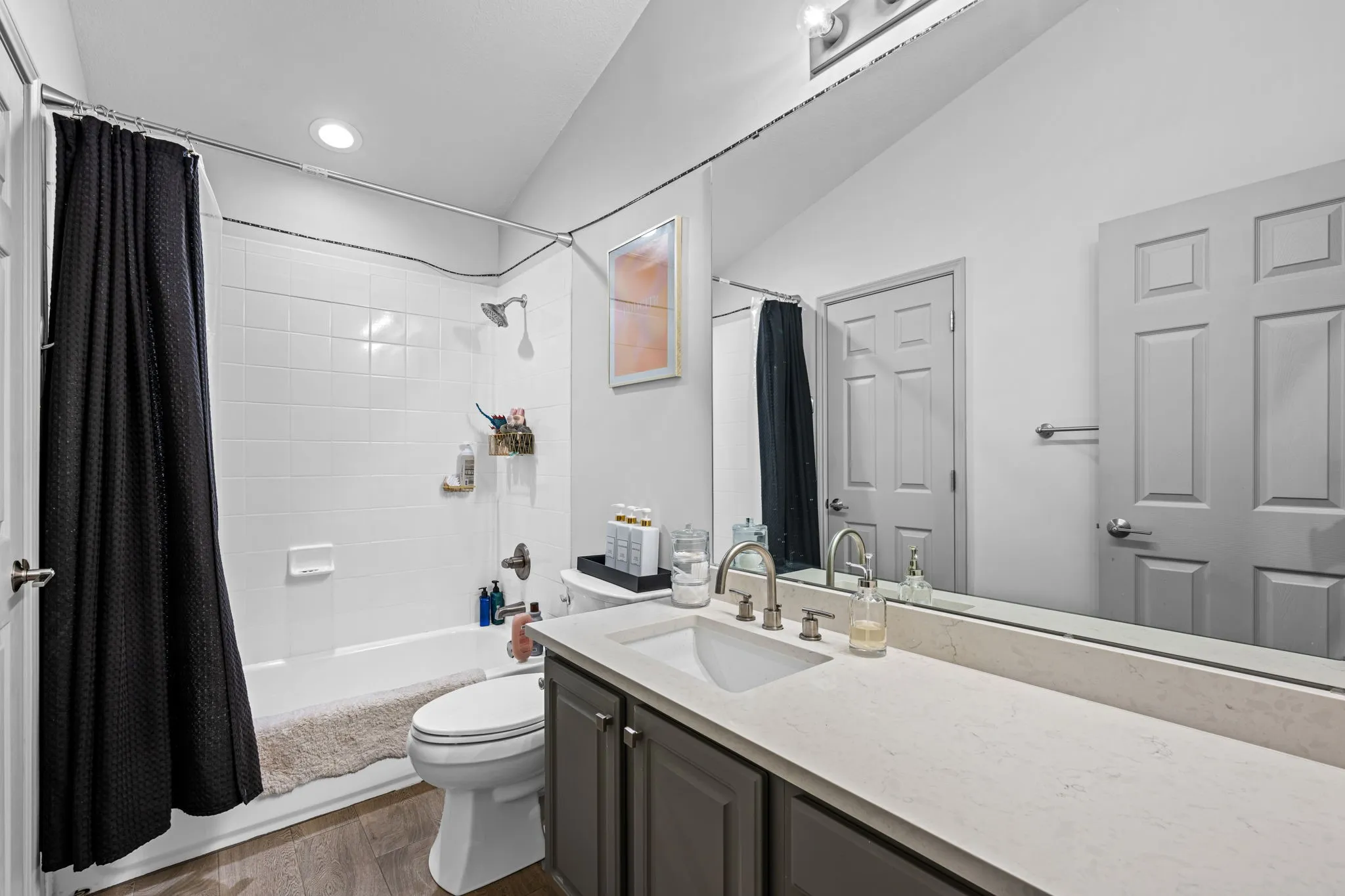 Full bathroom with a large vanity and tub-shower combo