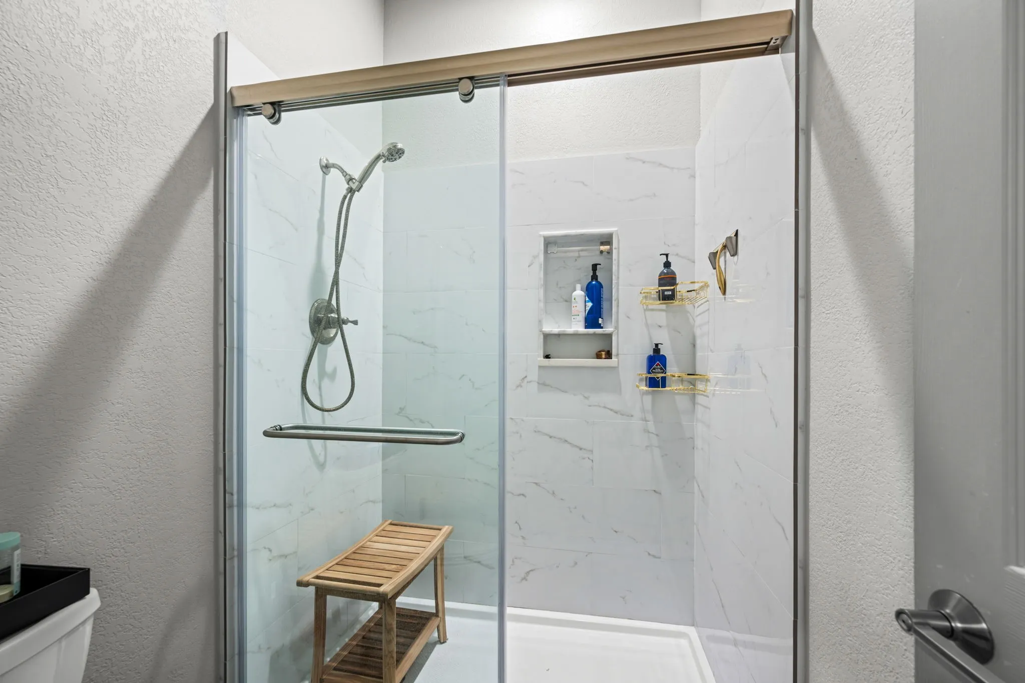 Glass-enclosed shower in the ensuite primary bathroom