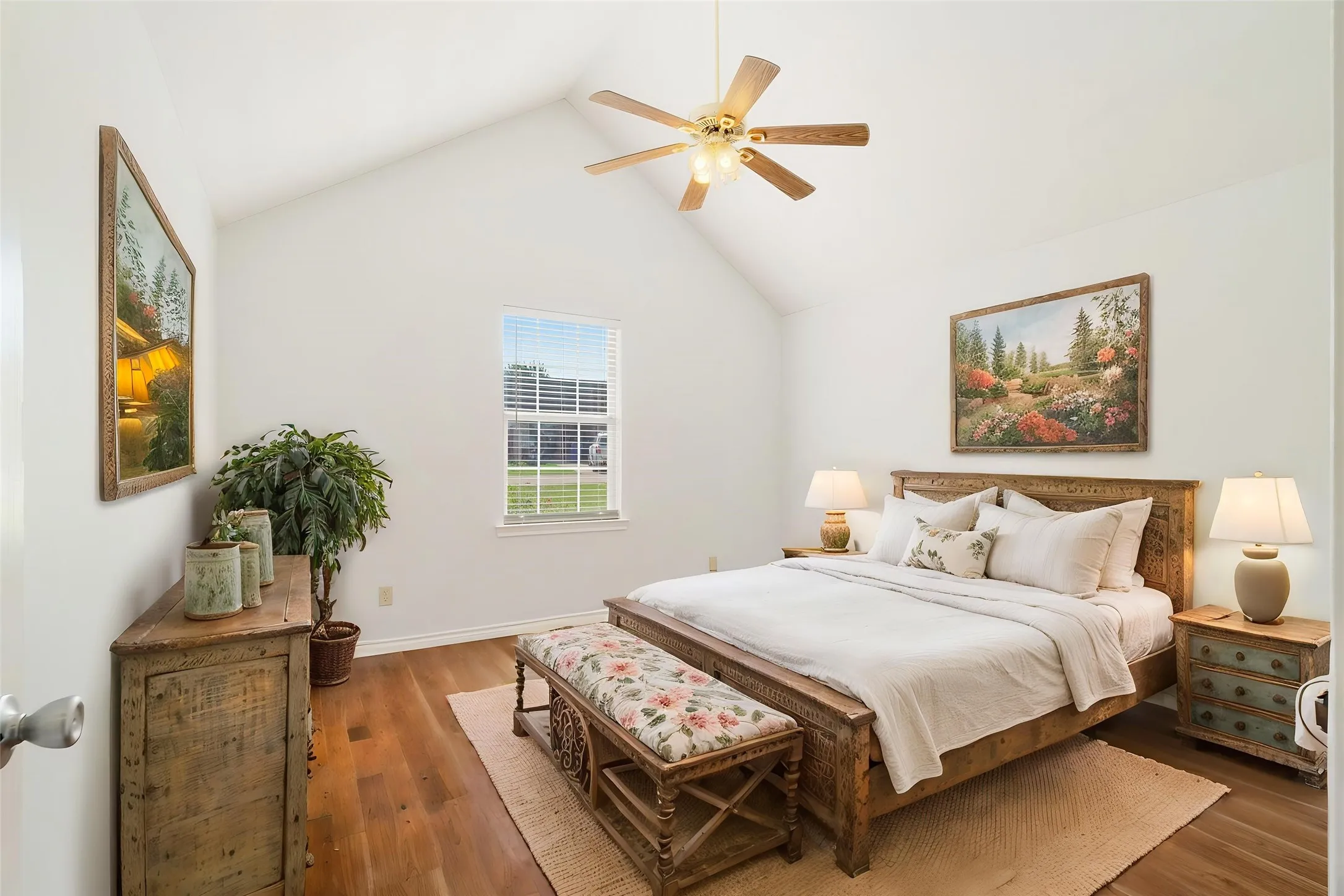 Vaulted ceiling with a ceiling fan, hardwood flooring, and a large window