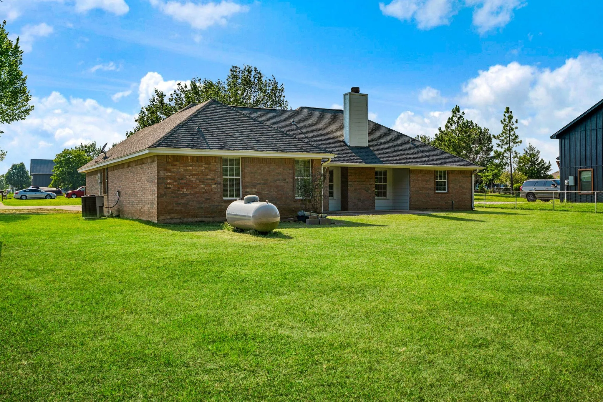 Brick exterior with a dark shingle roof and a prominent chimney