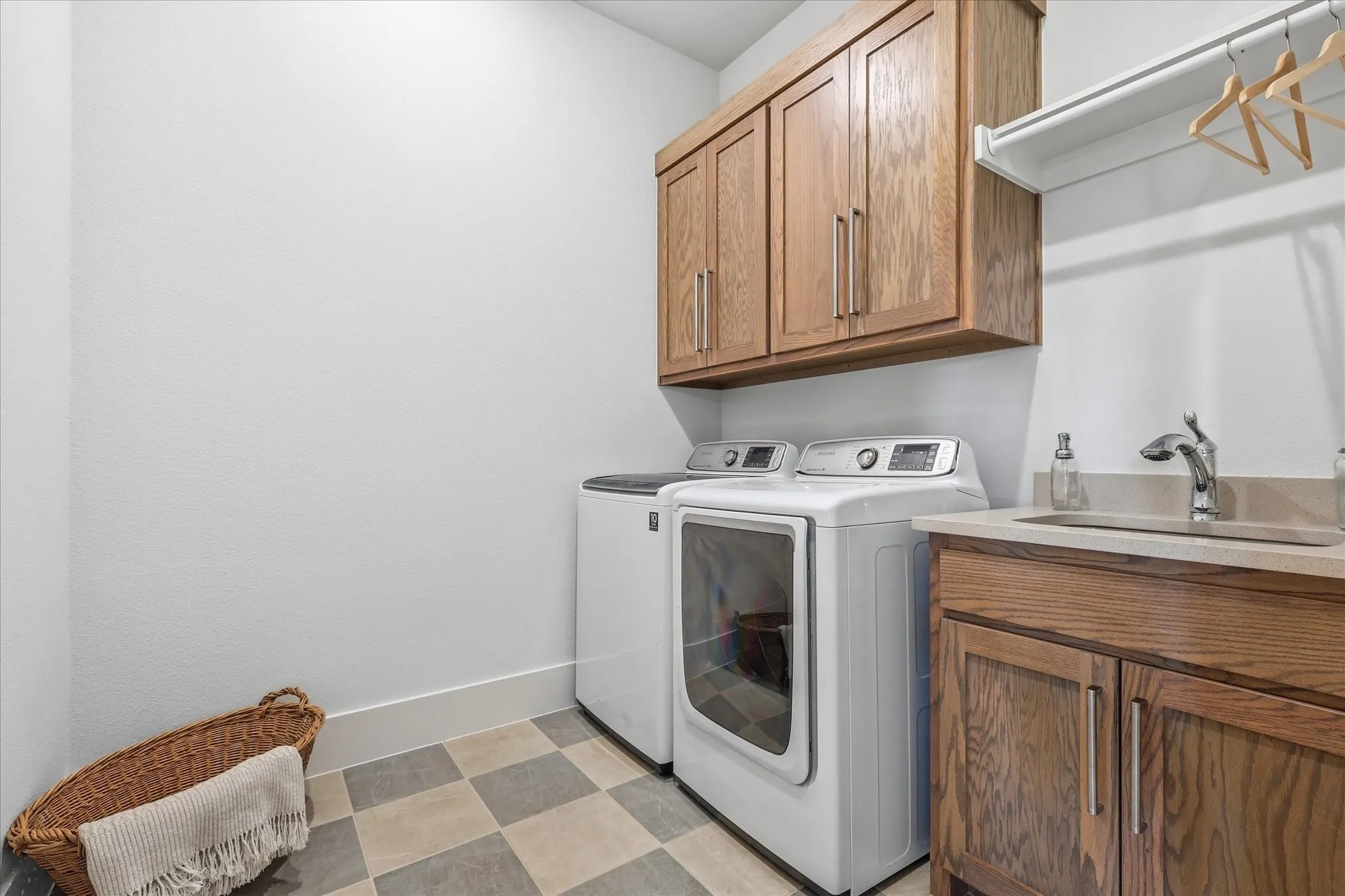 decorative floor tile and utility sink in the laundry room.