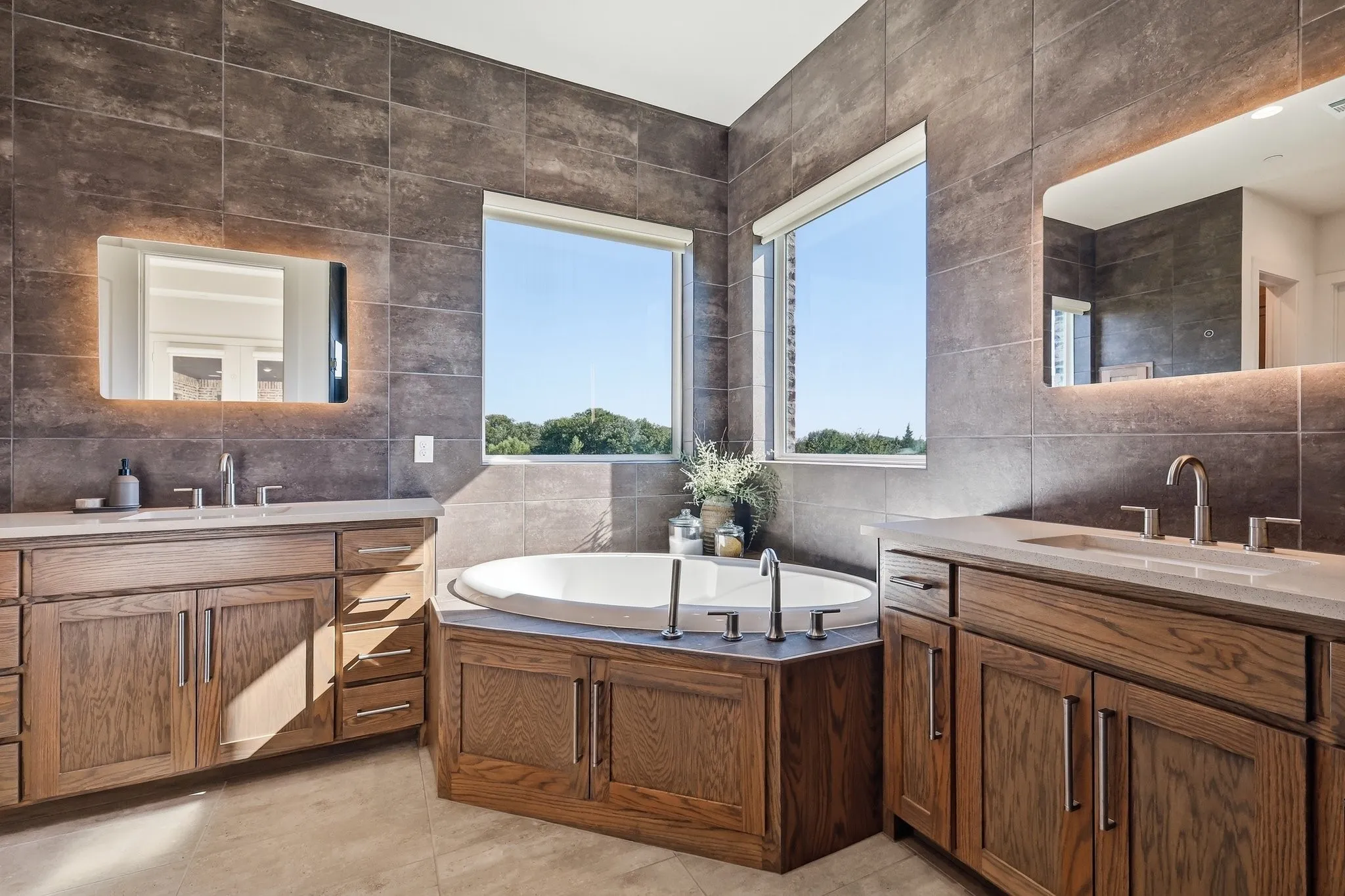 backlit mirrors and floor to ceiling tile