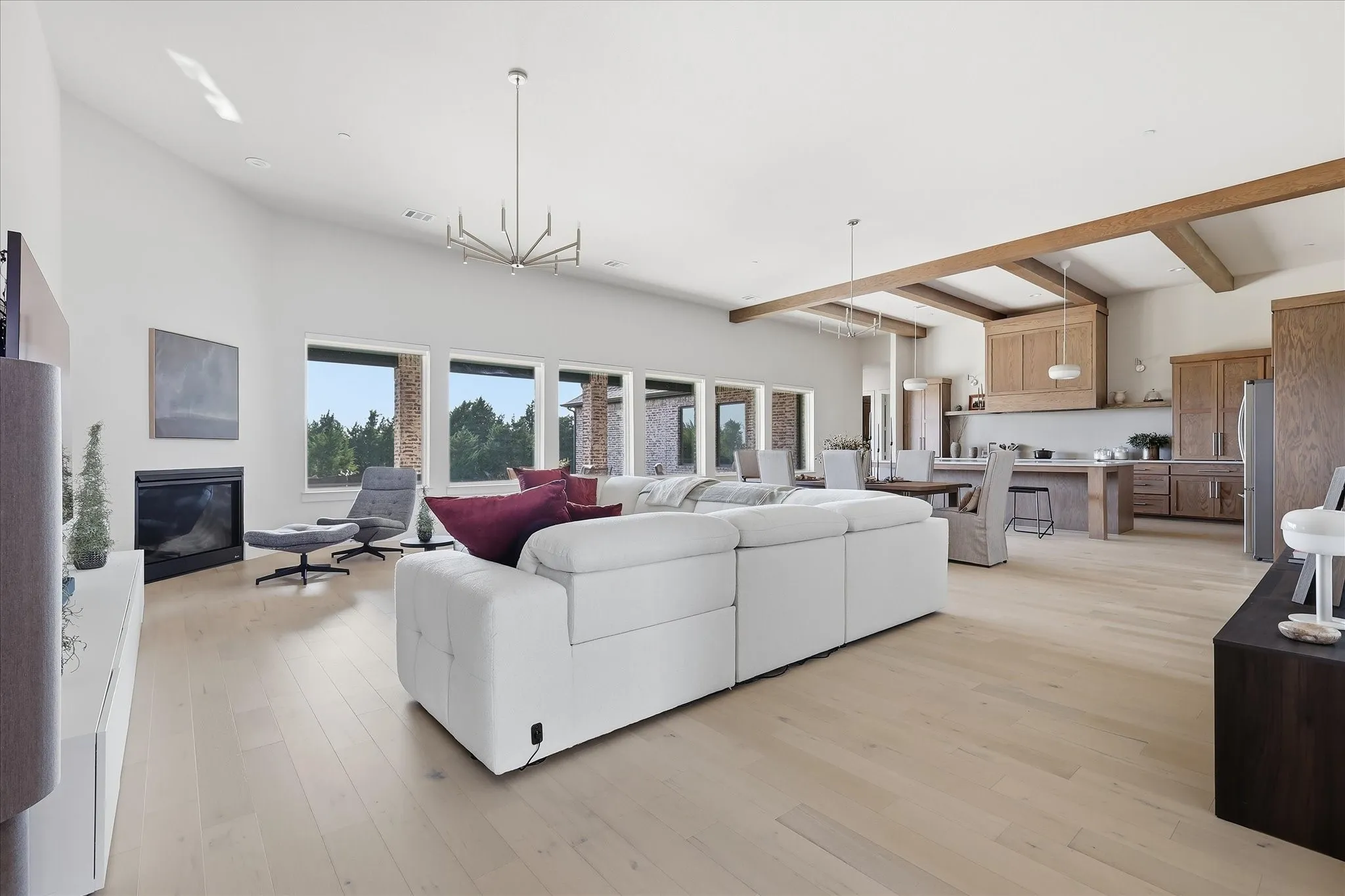 Open concept living, dining and kitchen is accesorized with wall of picture windows to the backyard.