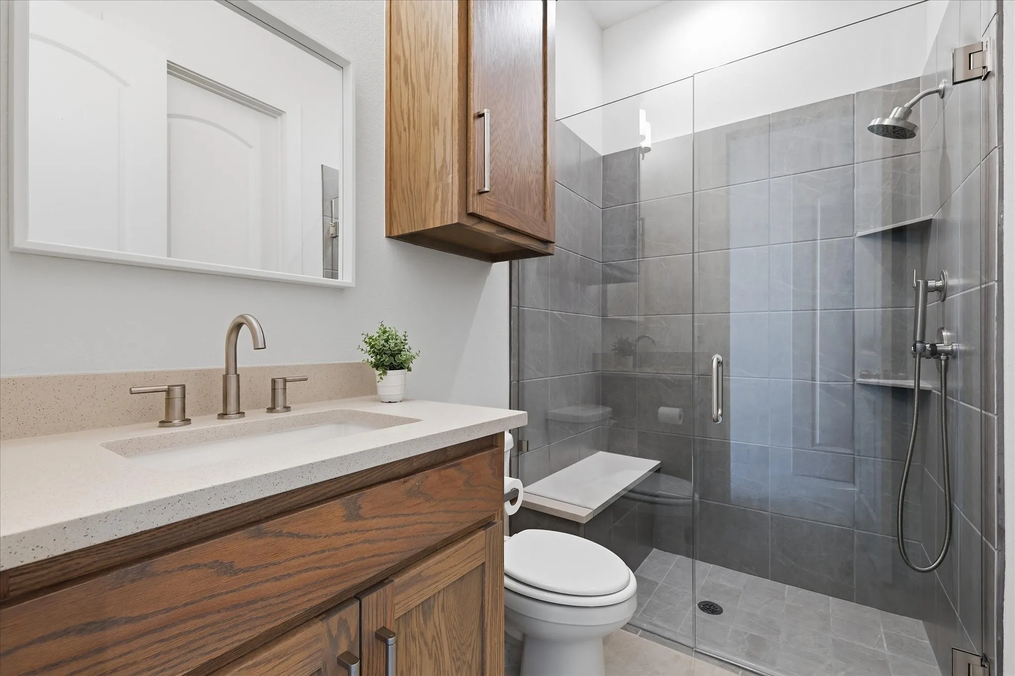 Ensuite with seamless glass shower door and large walk in closet