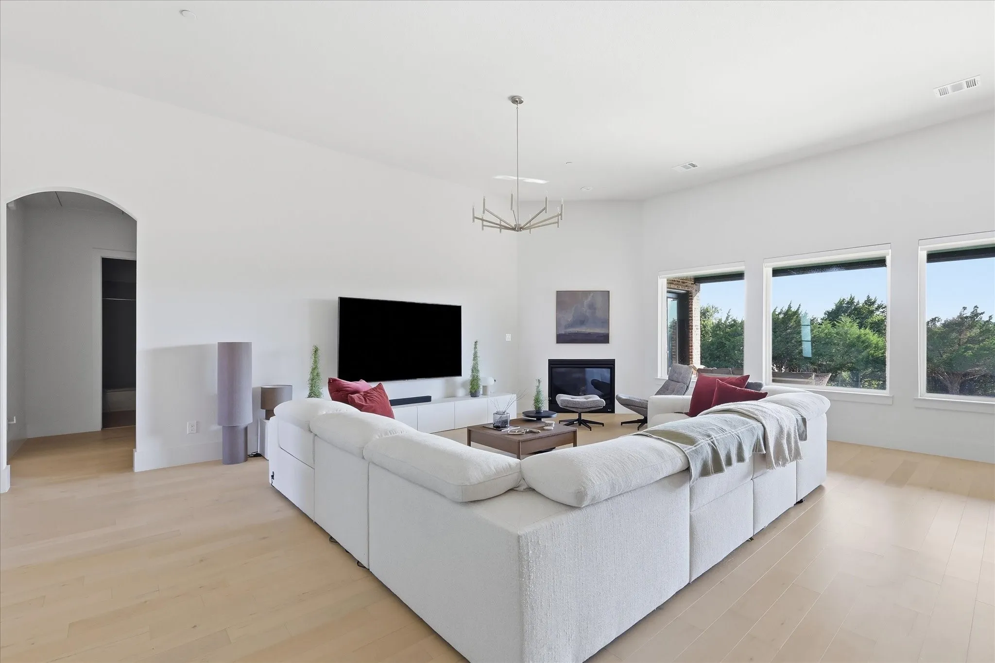 Upgraded chandeliers illuminate the living area while you cozy up to the gas fireplace.