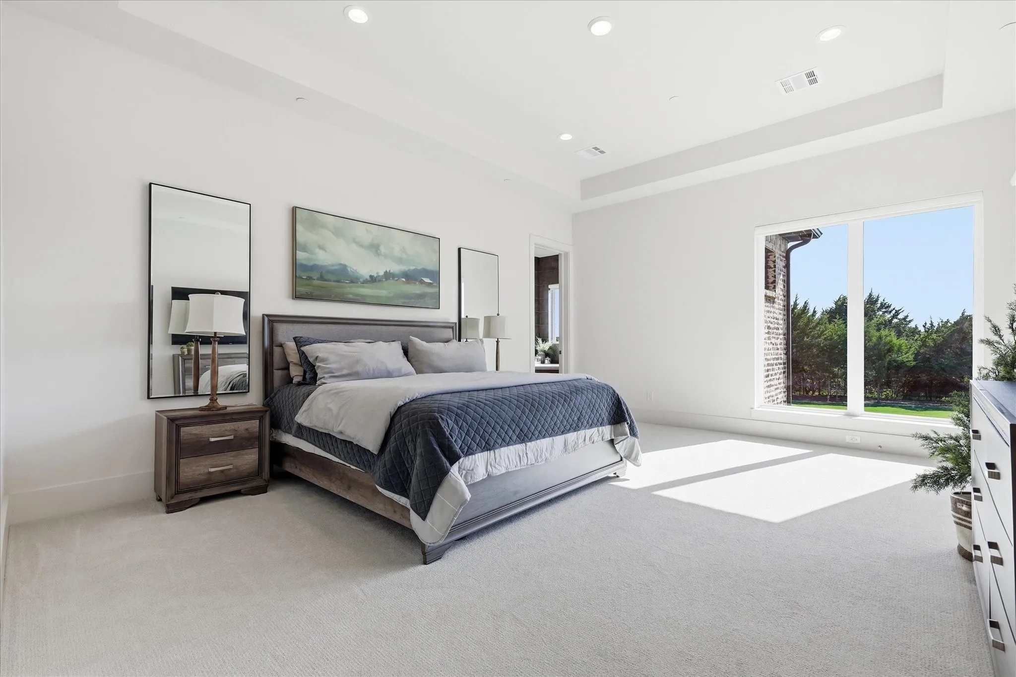 Primary bedroom has breathtaking views of the backyard with french doors to the covered patio.