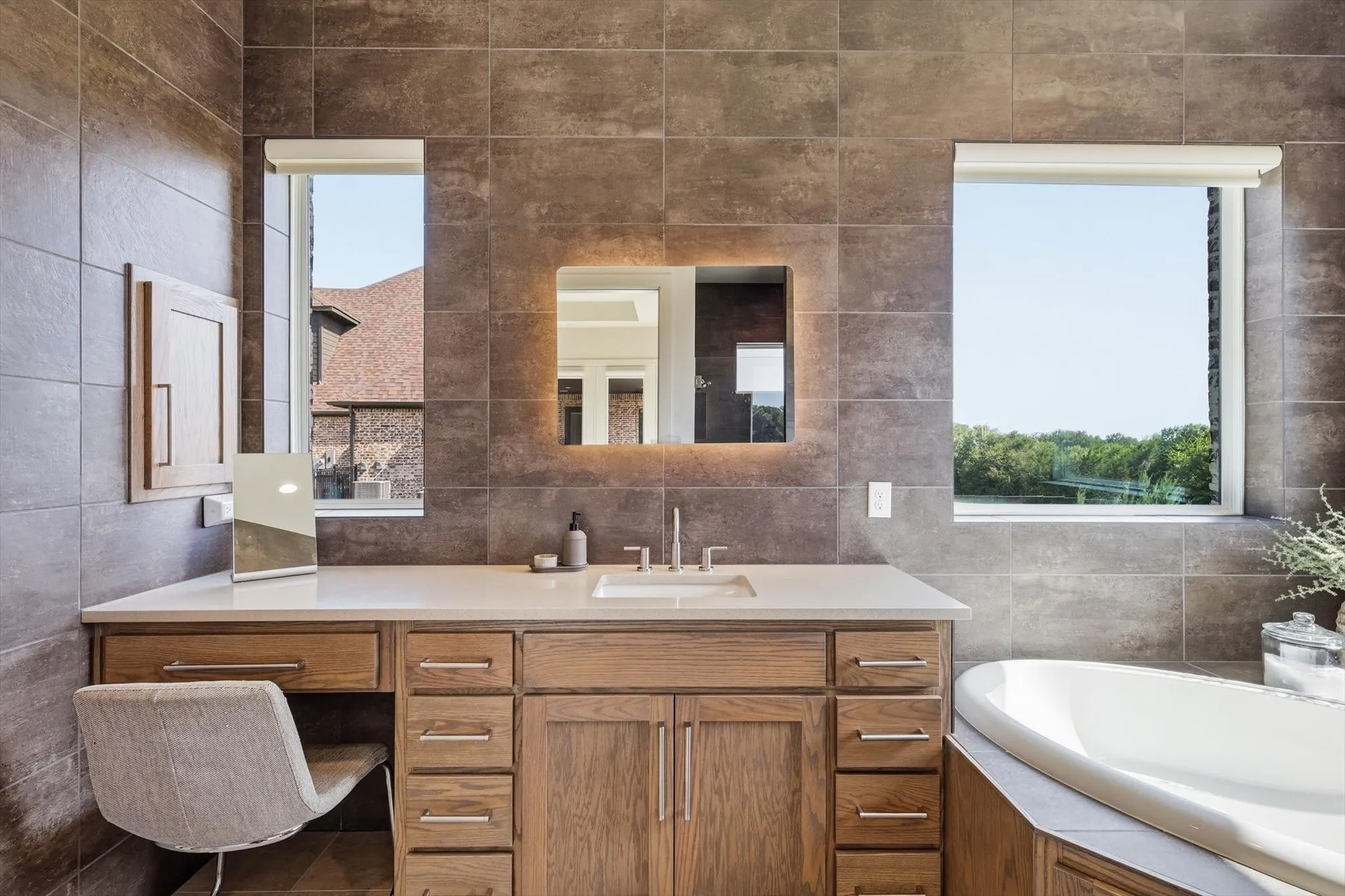 Make-up vanity and primary bathroom with ample natural light
