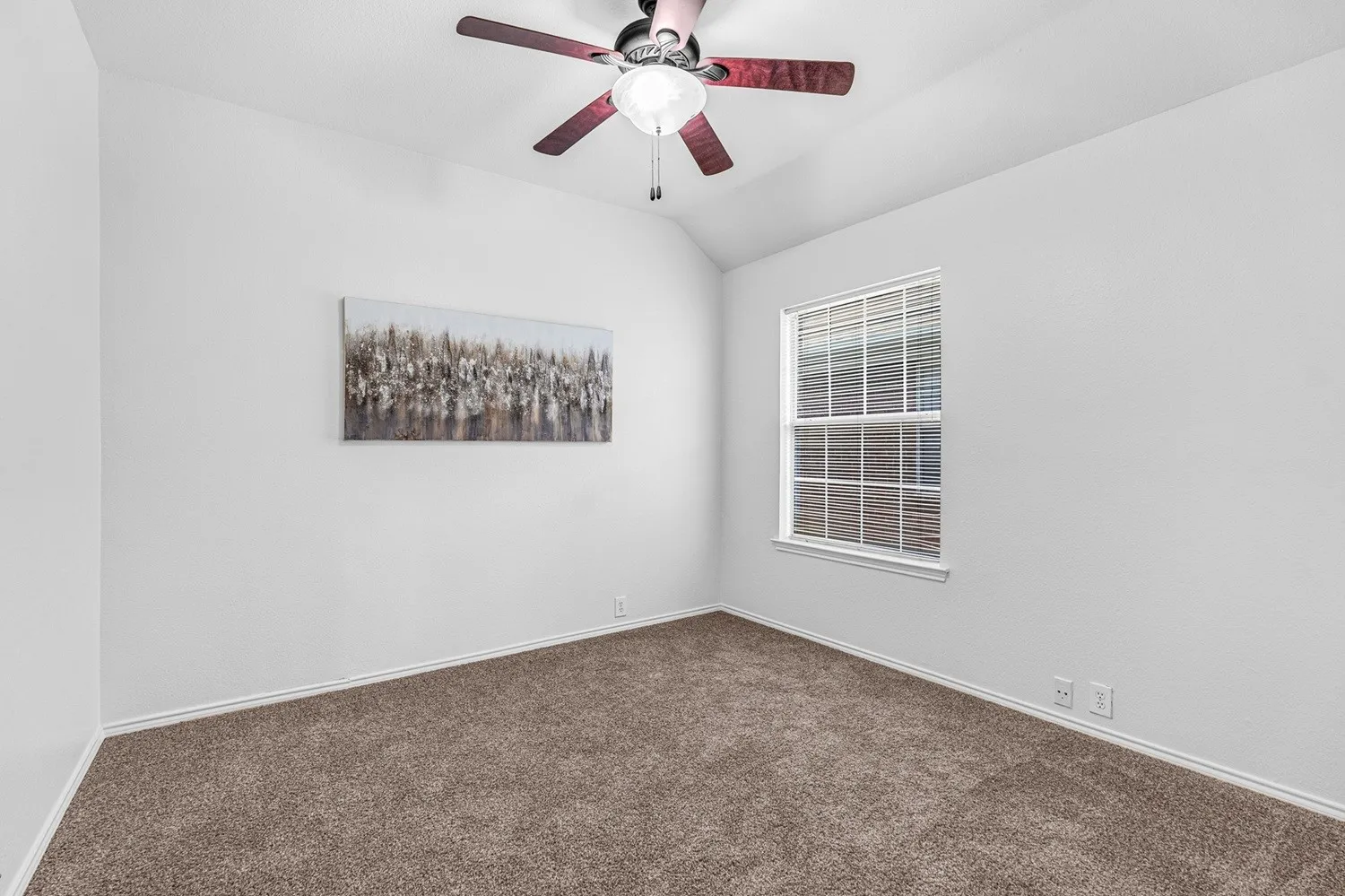 Vaulted ceiling featuring a ceiling fan with integrated lighting