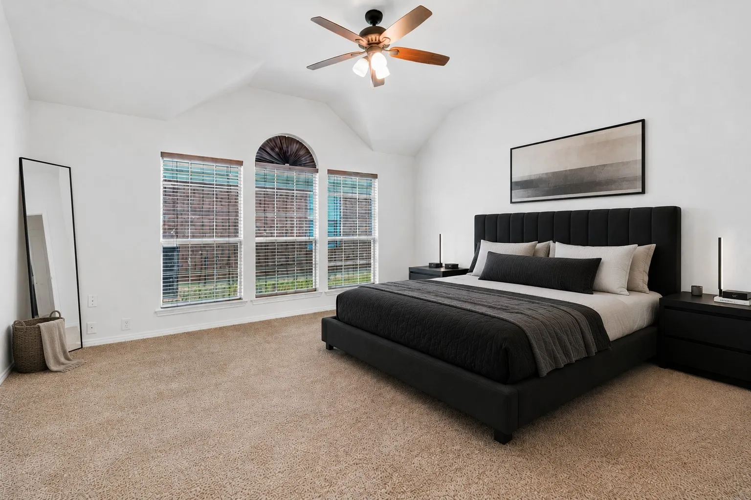 Vaulted ceiling bedroom with a ceiling fan light fixture
