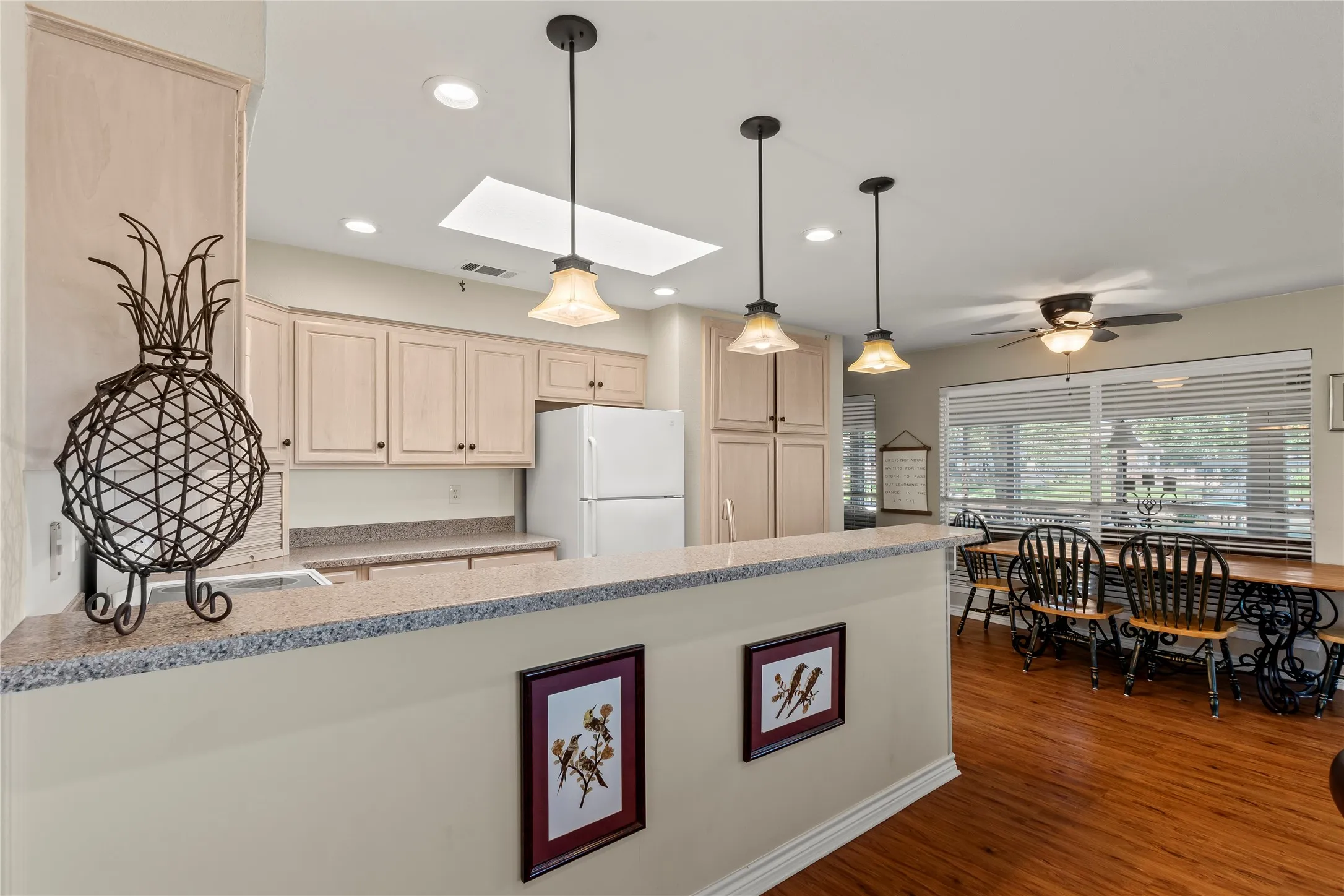 Open kitchen with wraparound lake views, perfectly positioned off the living room to keep you connected with family and guests while cooking.
