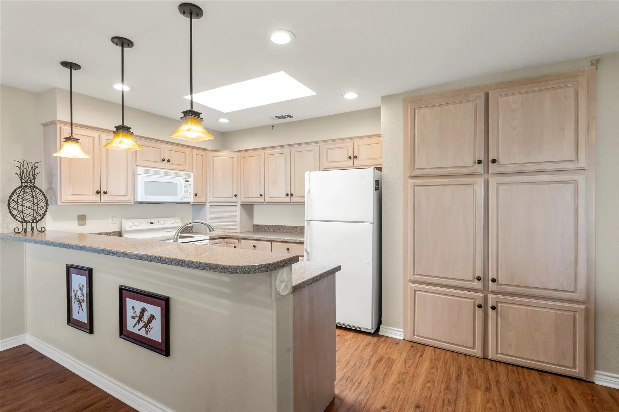 Open kitchen with ample cabinetry and convenient access to the dining and living areas.