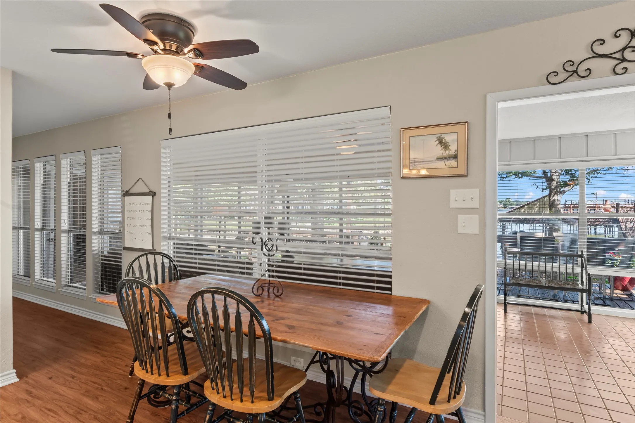 Dining area overlooking the glass enclosed sunroom and lake.