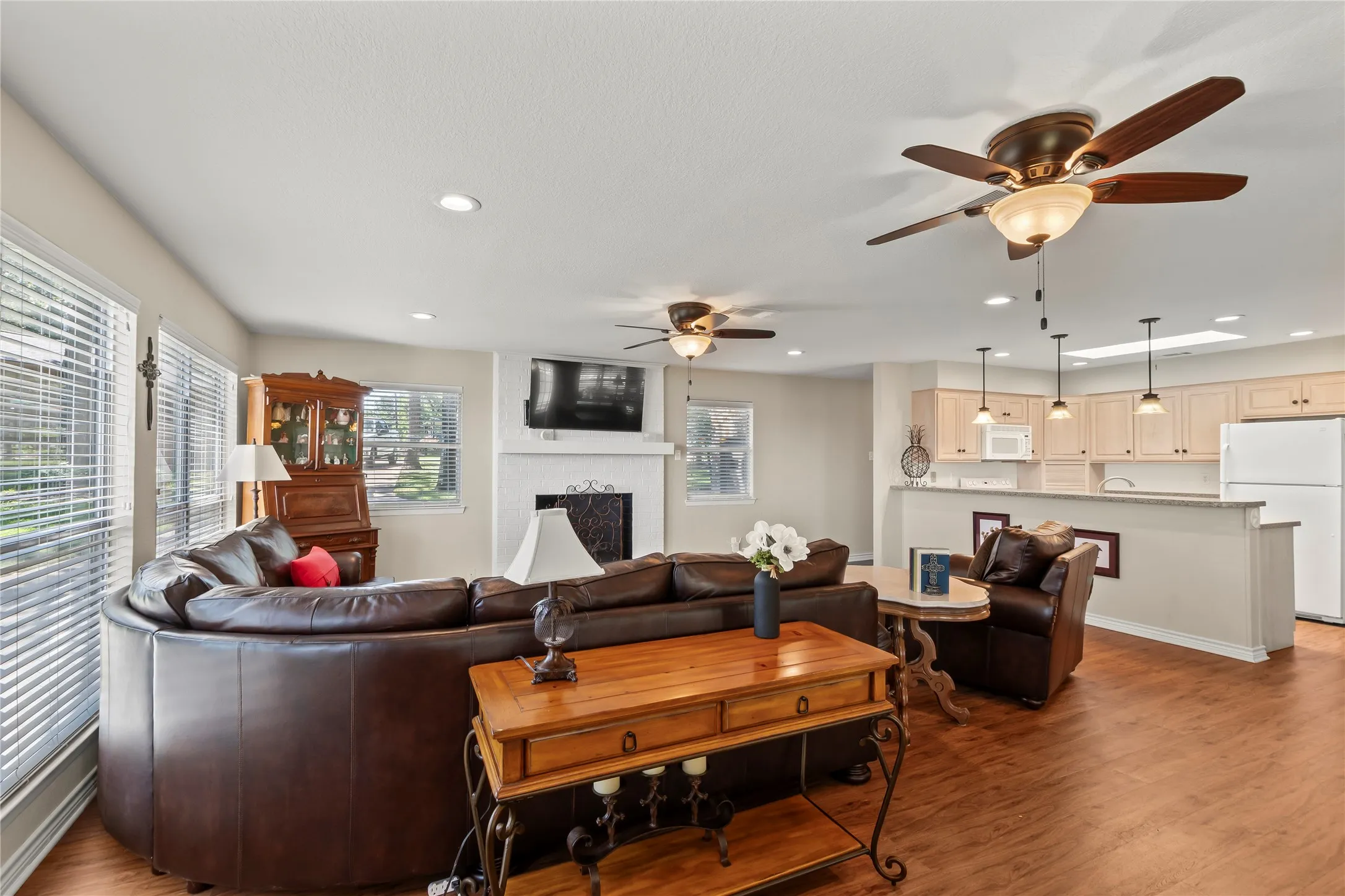 Open concept living room flowing into kitchen and dining area.