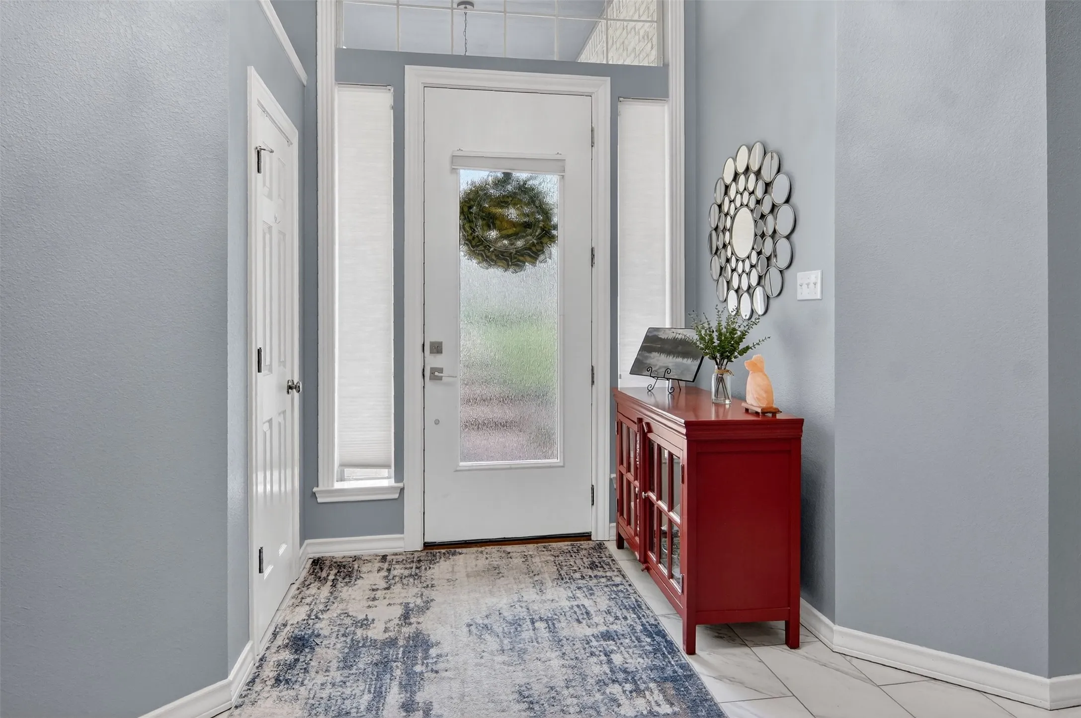The bright foyer welcomes you home every day.