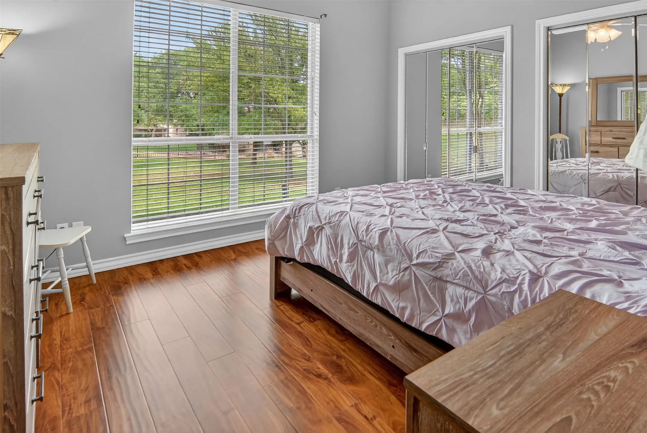 Large window, ceiling fan, and ample closet space in this nice-sized bedroom.