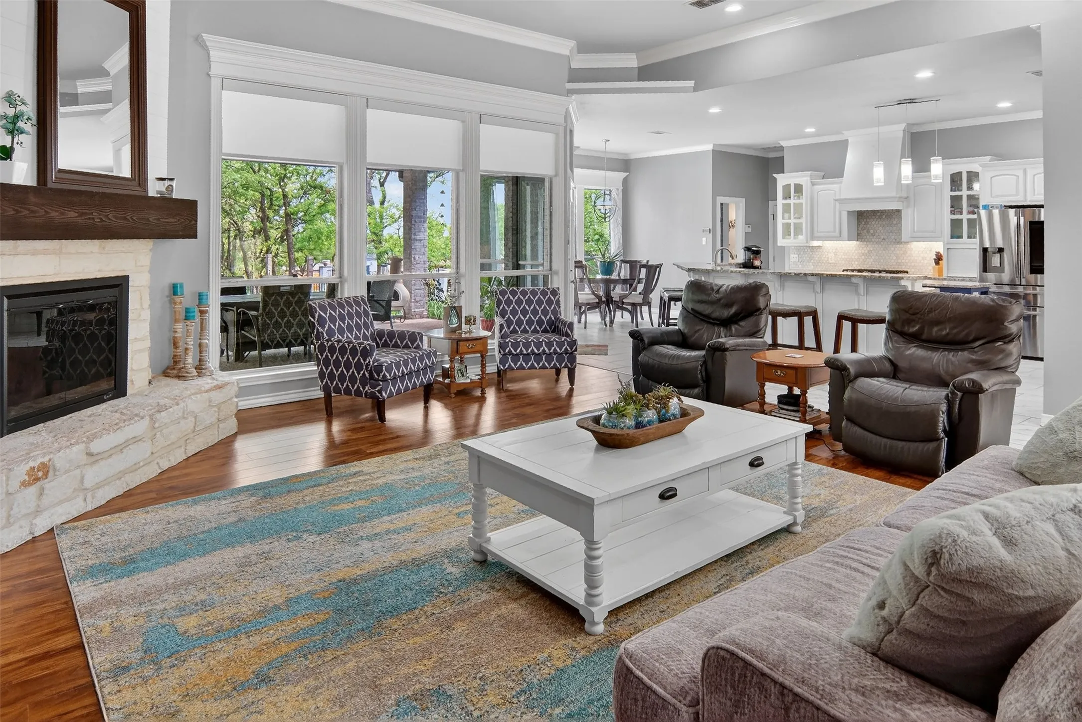 Wide open, spacious family room with crown molding and wood floors.