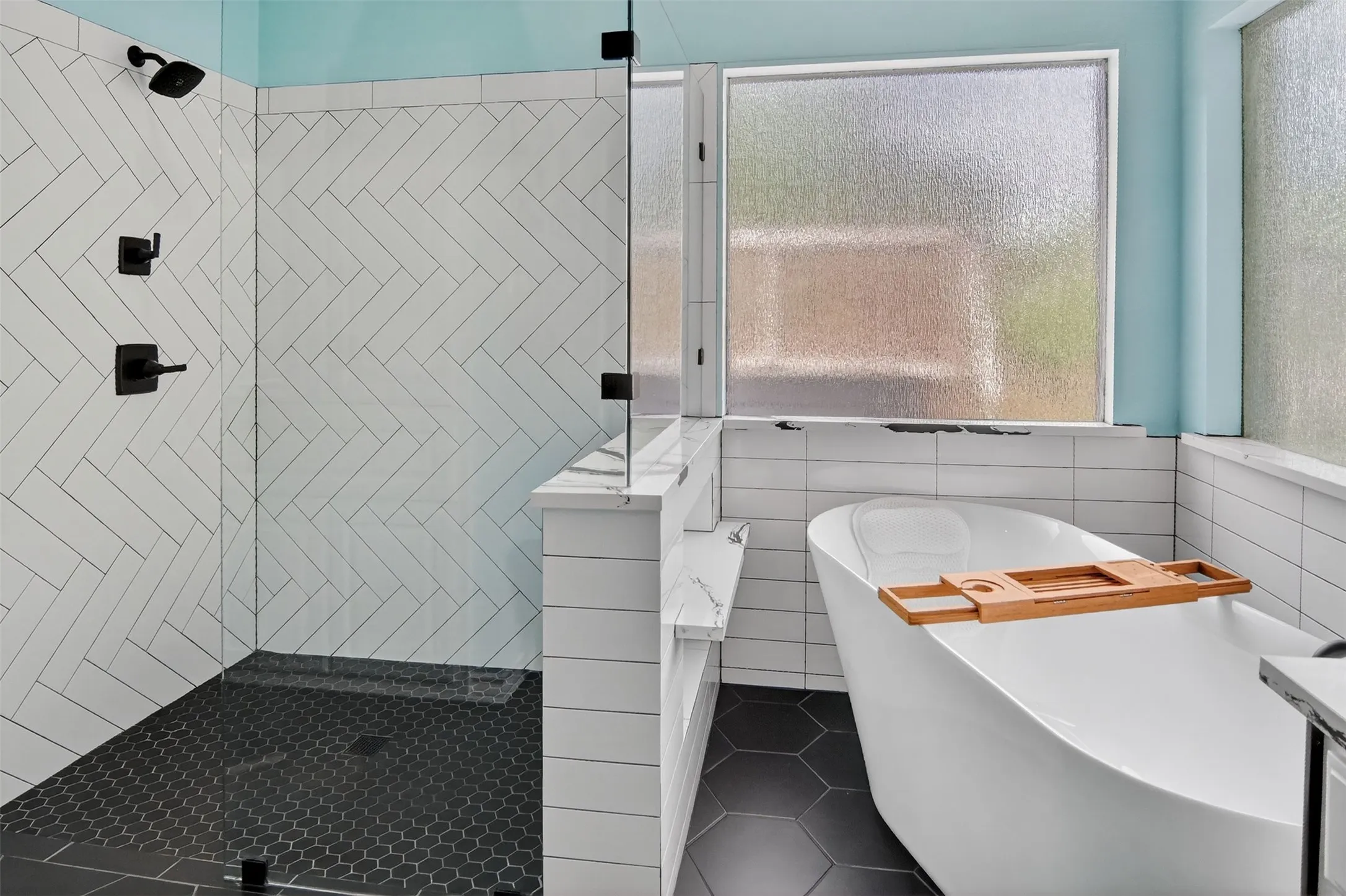 Ensuite bathroom with large free-standing soaking tub and separate walk-in shower.