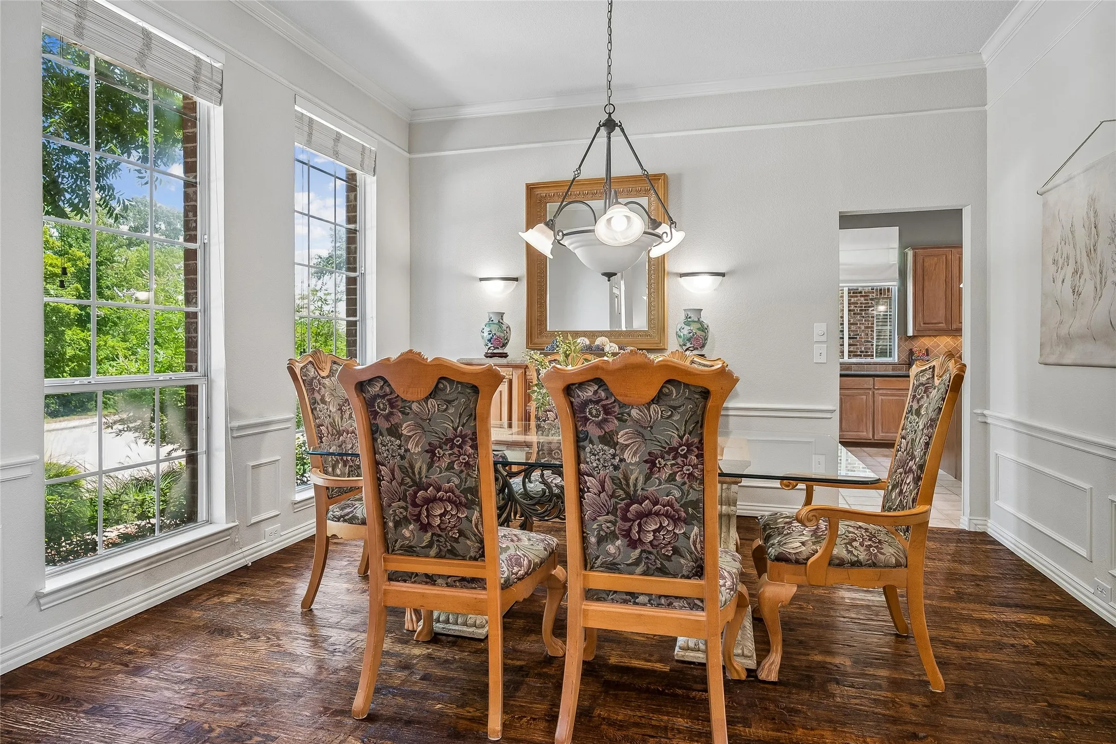 Formal dining room with wood floors, chair rail. chandelier and lots of natural light.