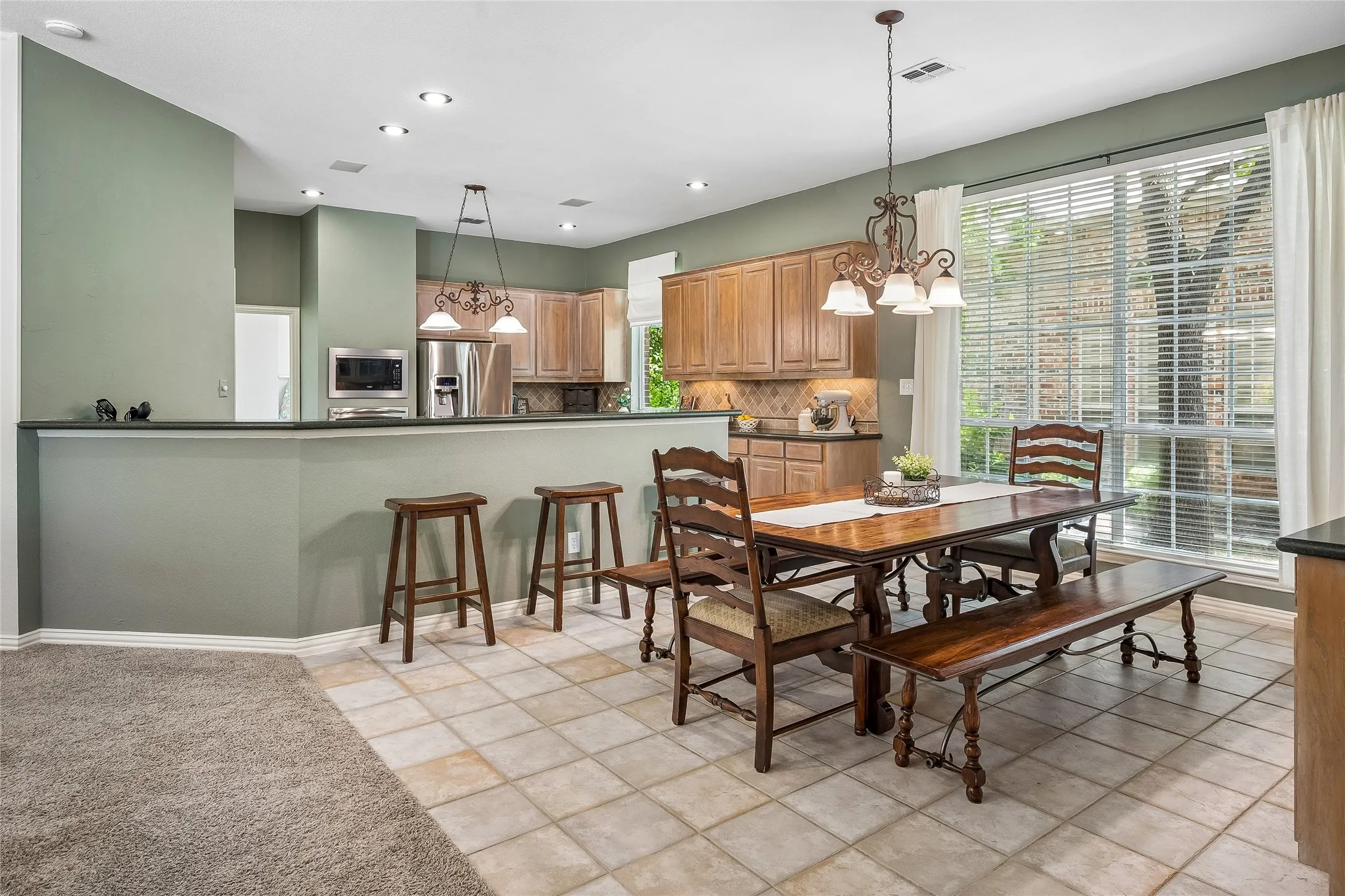Spacious eating area with lots of windows perfect for casual entertaining of family or friends.