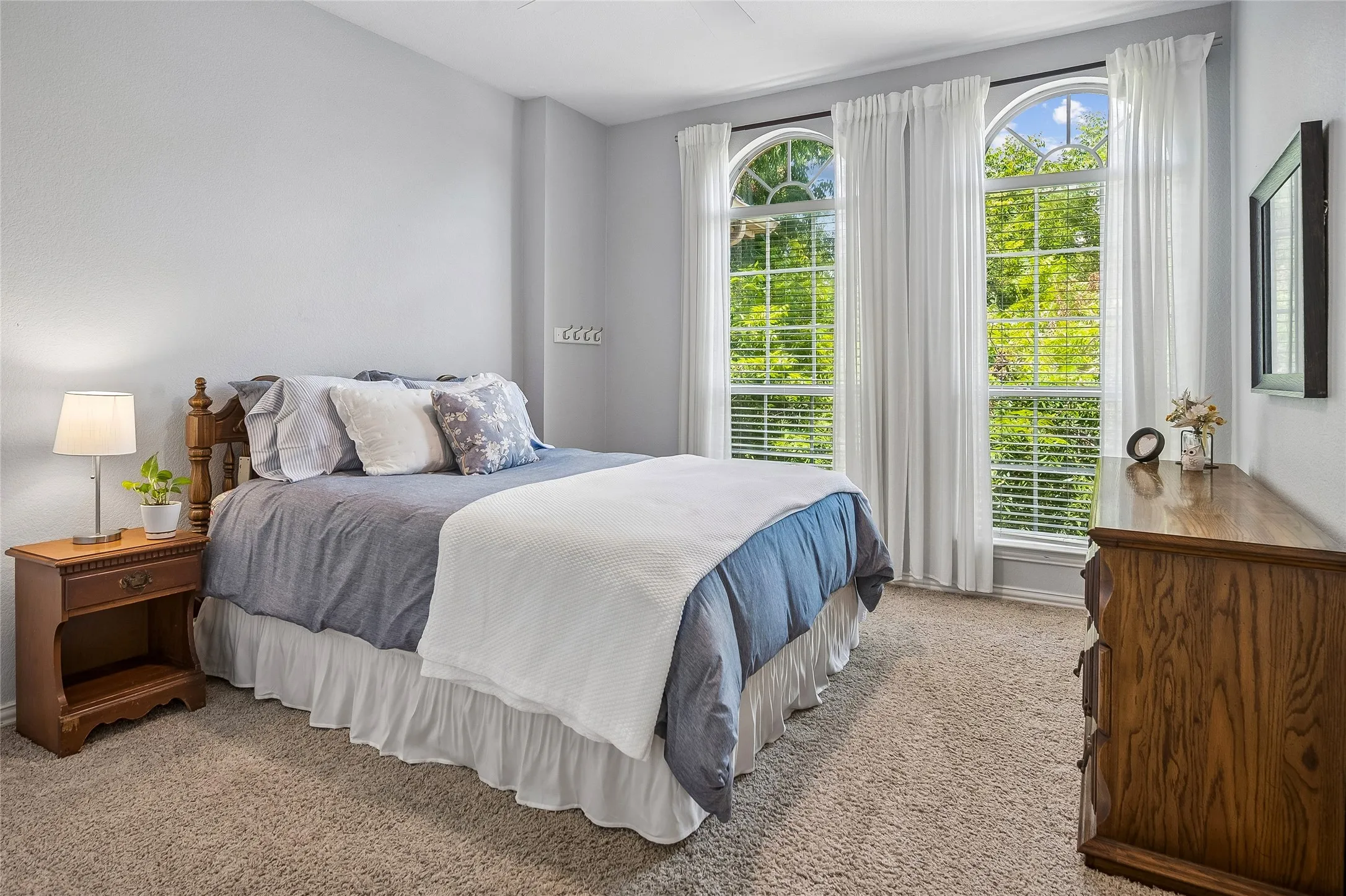 Bedroom with tall windows with eyebrows.