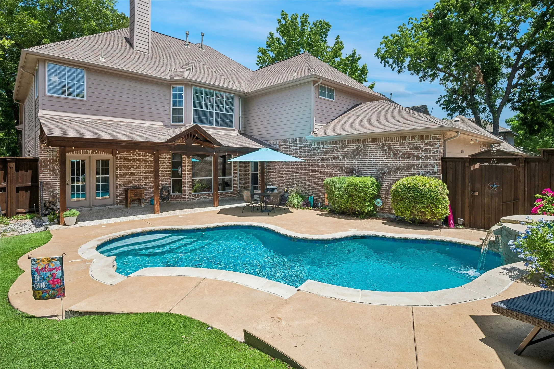 Saltwater pool with levels for interest, artificial grass, long covered patio.