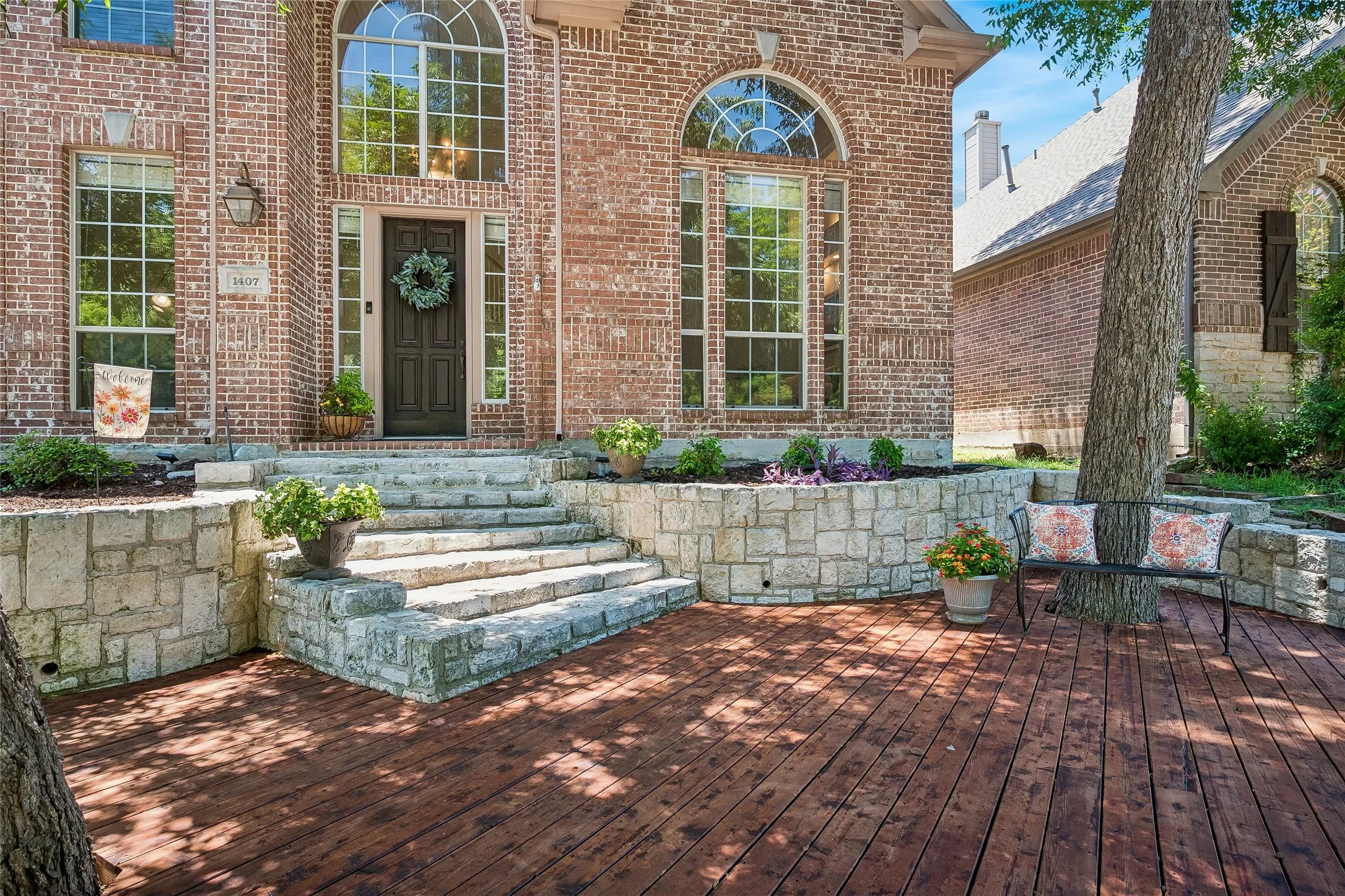 From this front deck you relax and watch the world go by or enjoy the beautiful greenbelt across the street.