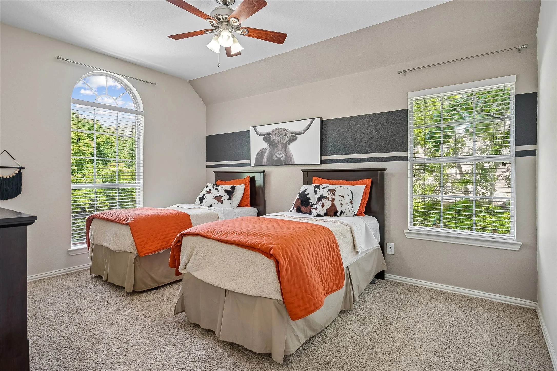 Secondary bedroom boasts two windows and a ceiling fan.