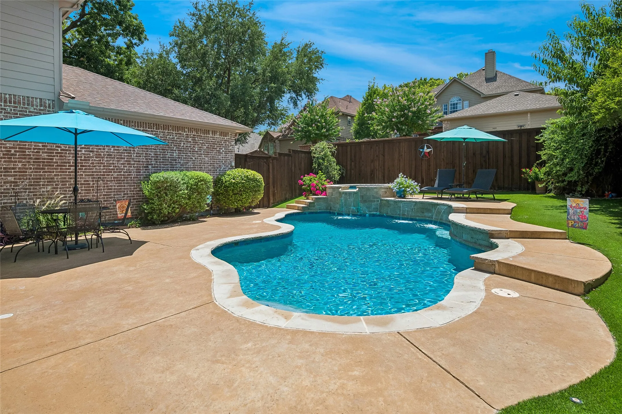 Saltwater pool has spa and waterfall.