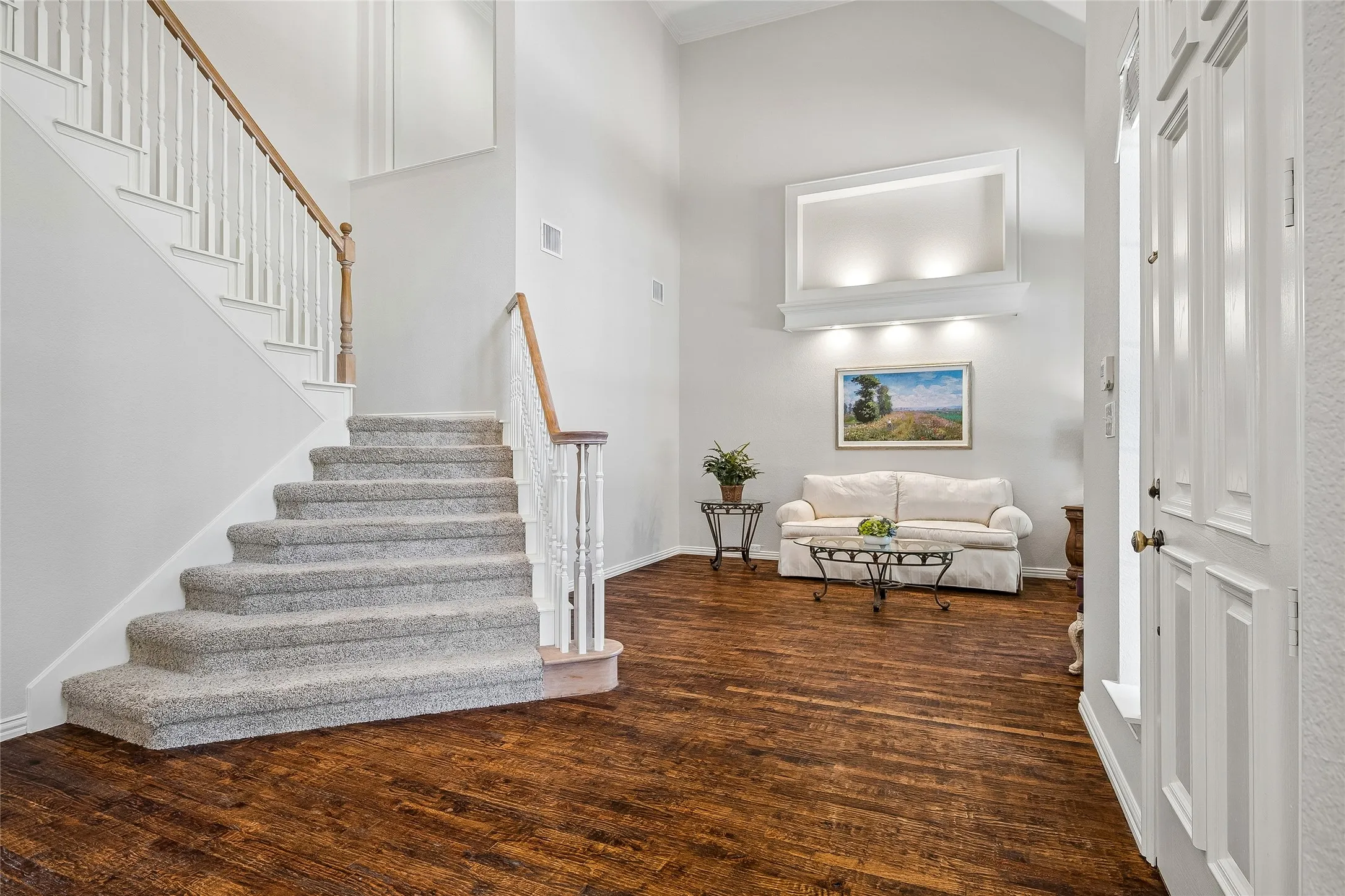 Welcoming entry with two story ceiling and wood floors.