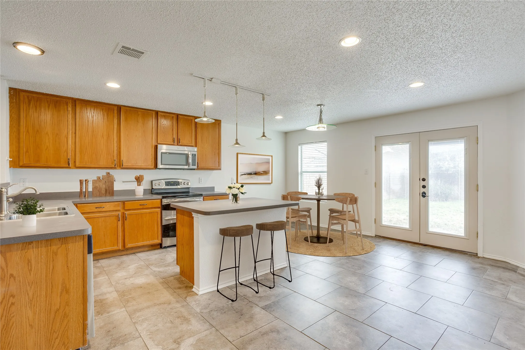 Virtually staged kitchen and breakfast area.