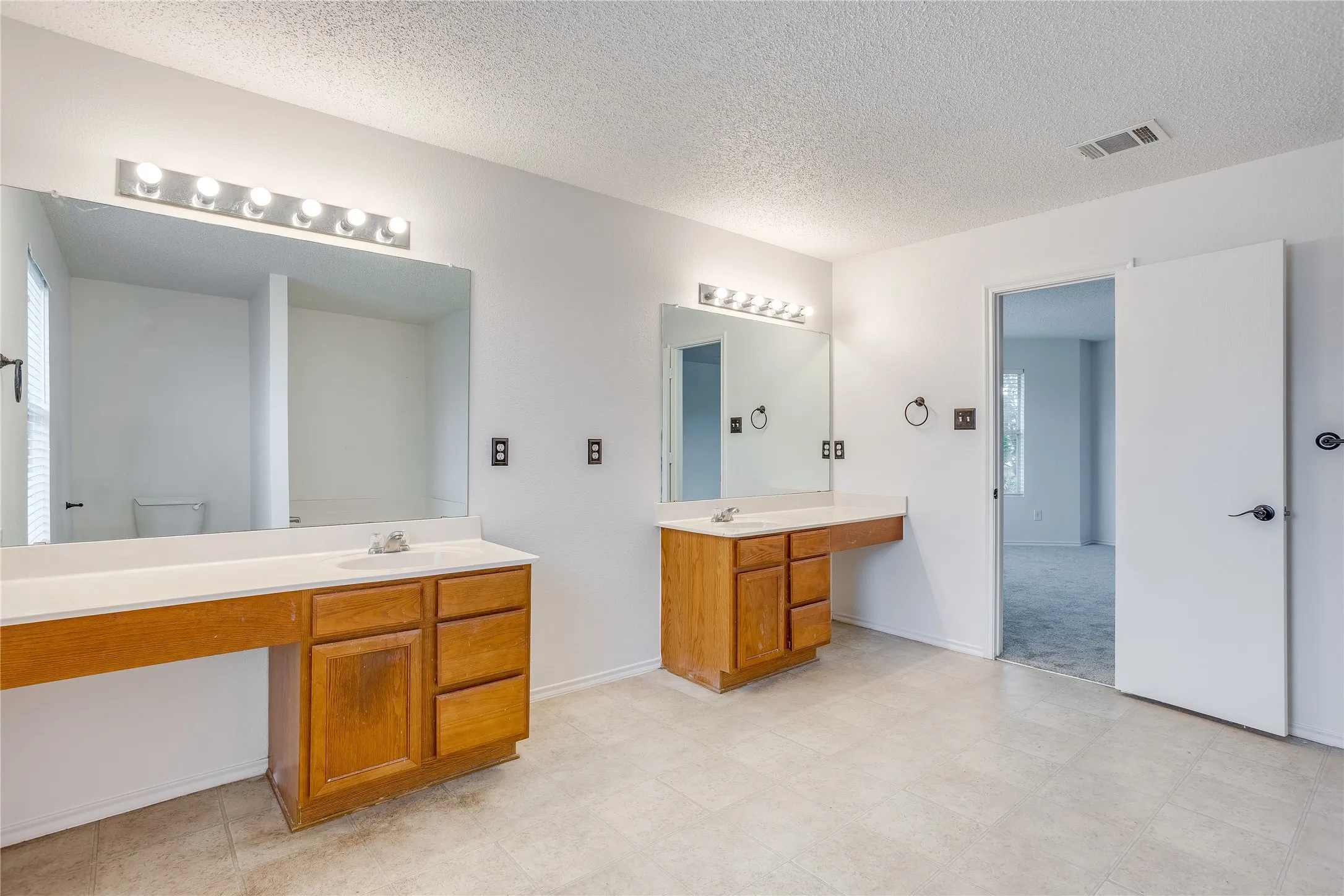 Upstairs Ensuite Bathroom features separate vanities, soaking tub and stand up shower.