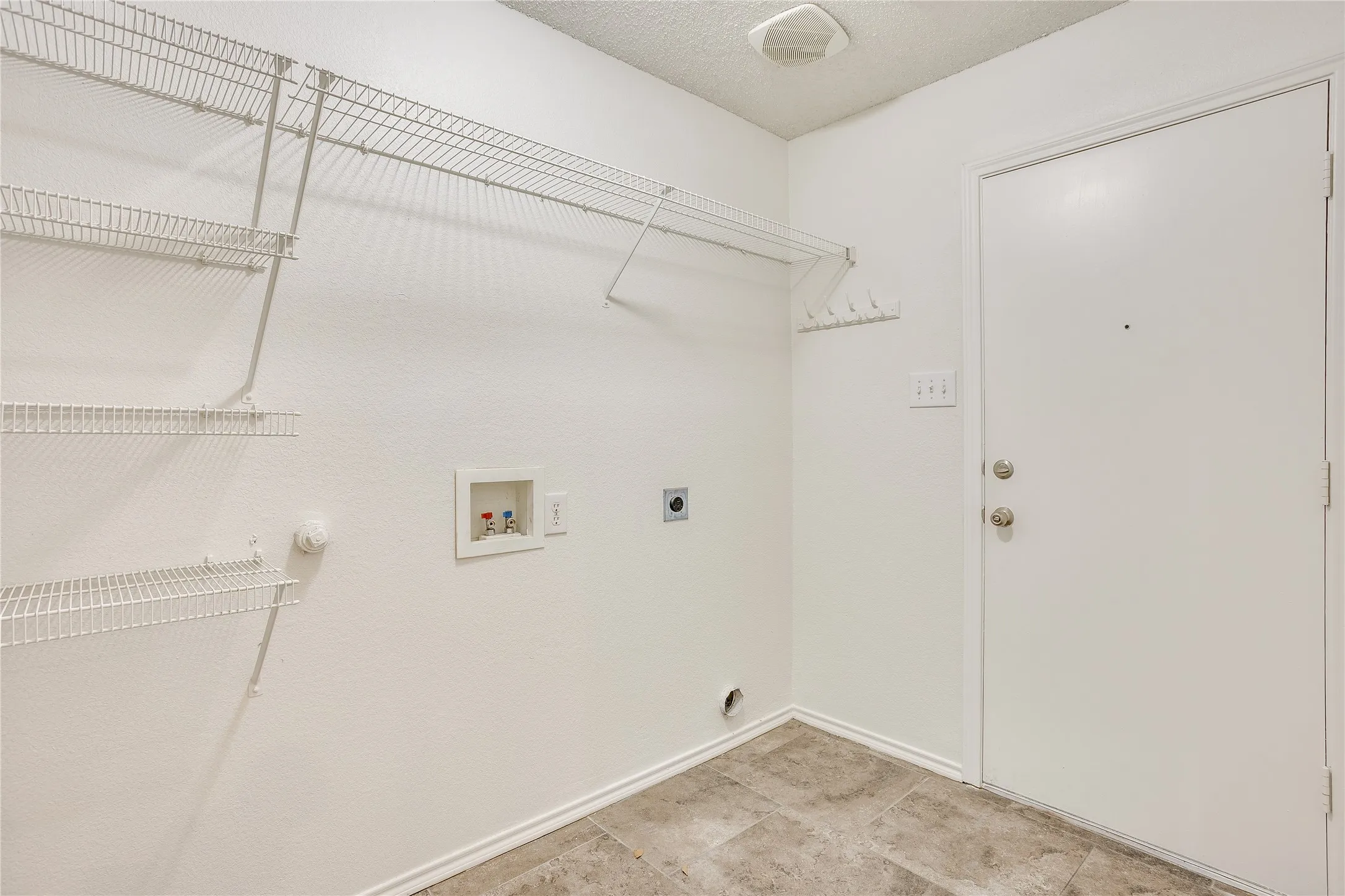 Large laundry room with lots of shelving