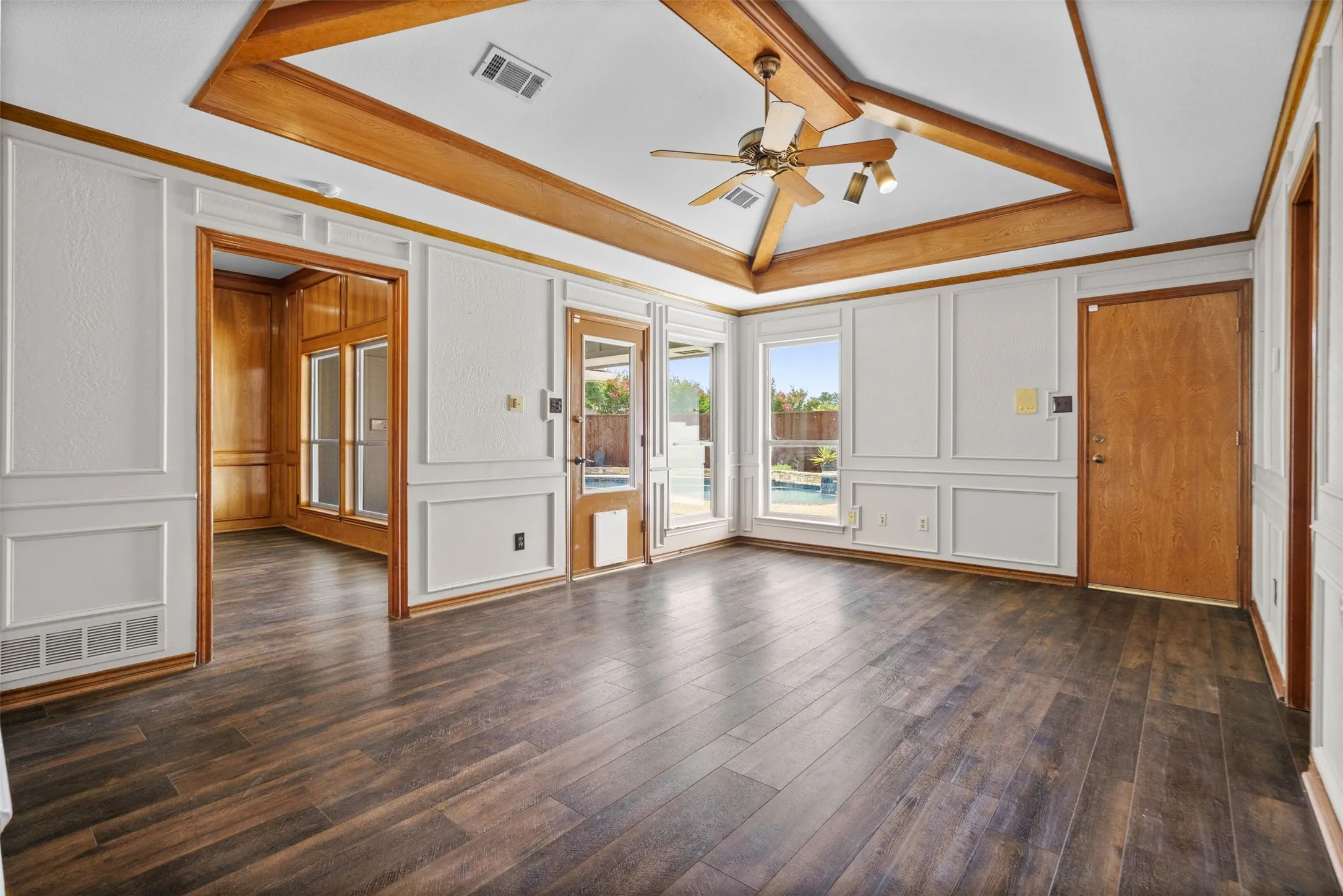 Second living space looking out to pool with a wet bar